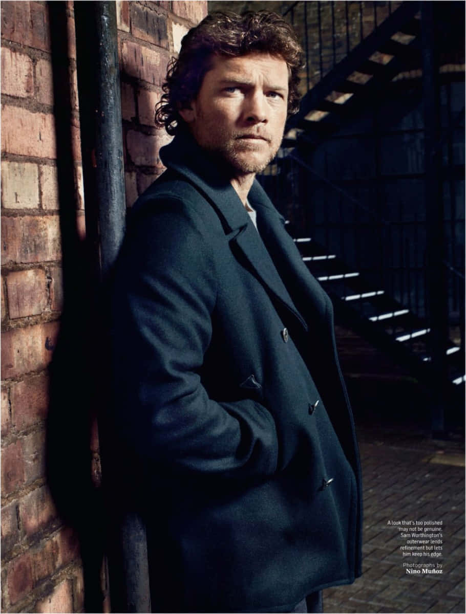 Sam Worthington, dark coat, brick wall, SD Phone Wallpaper