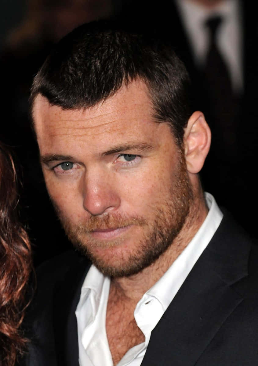 Sam Worthington, lip bite, black suit, SD Phone Wallpaper