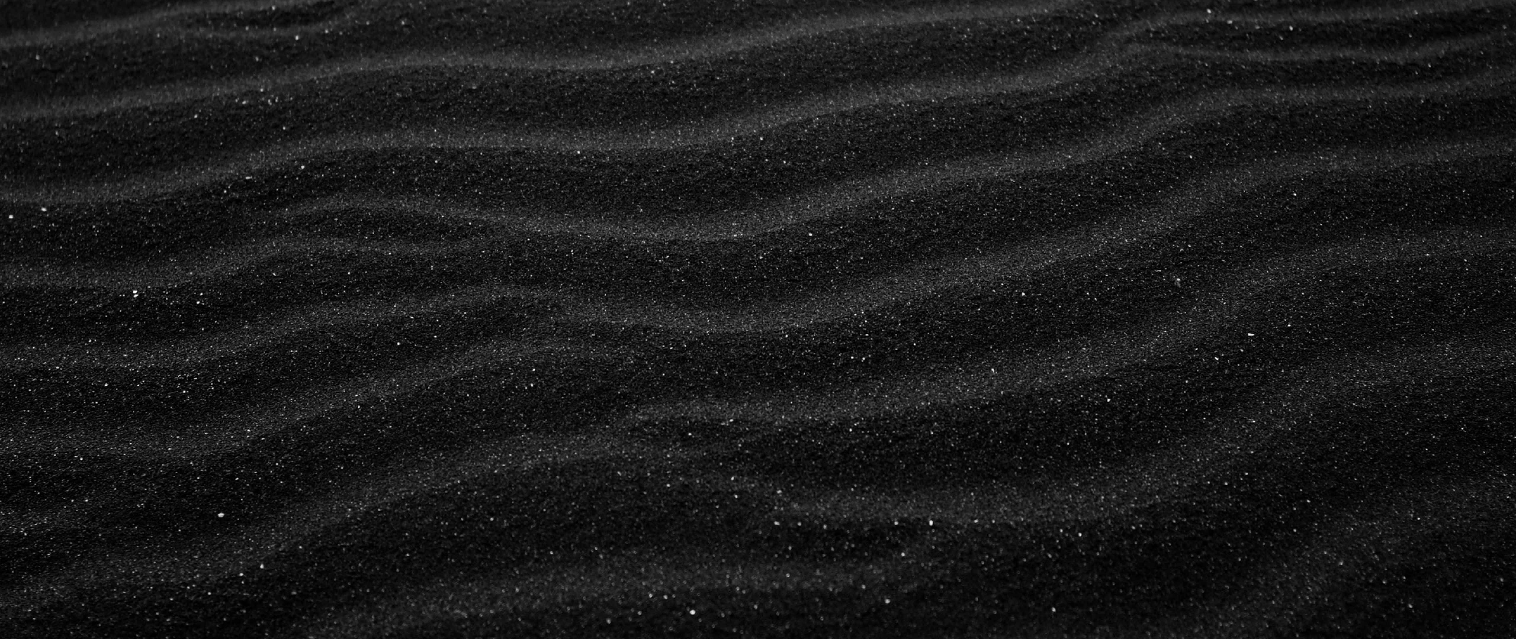 dark beach sand, fine ripples, glittering specks, 5K Desktop Wallpaper