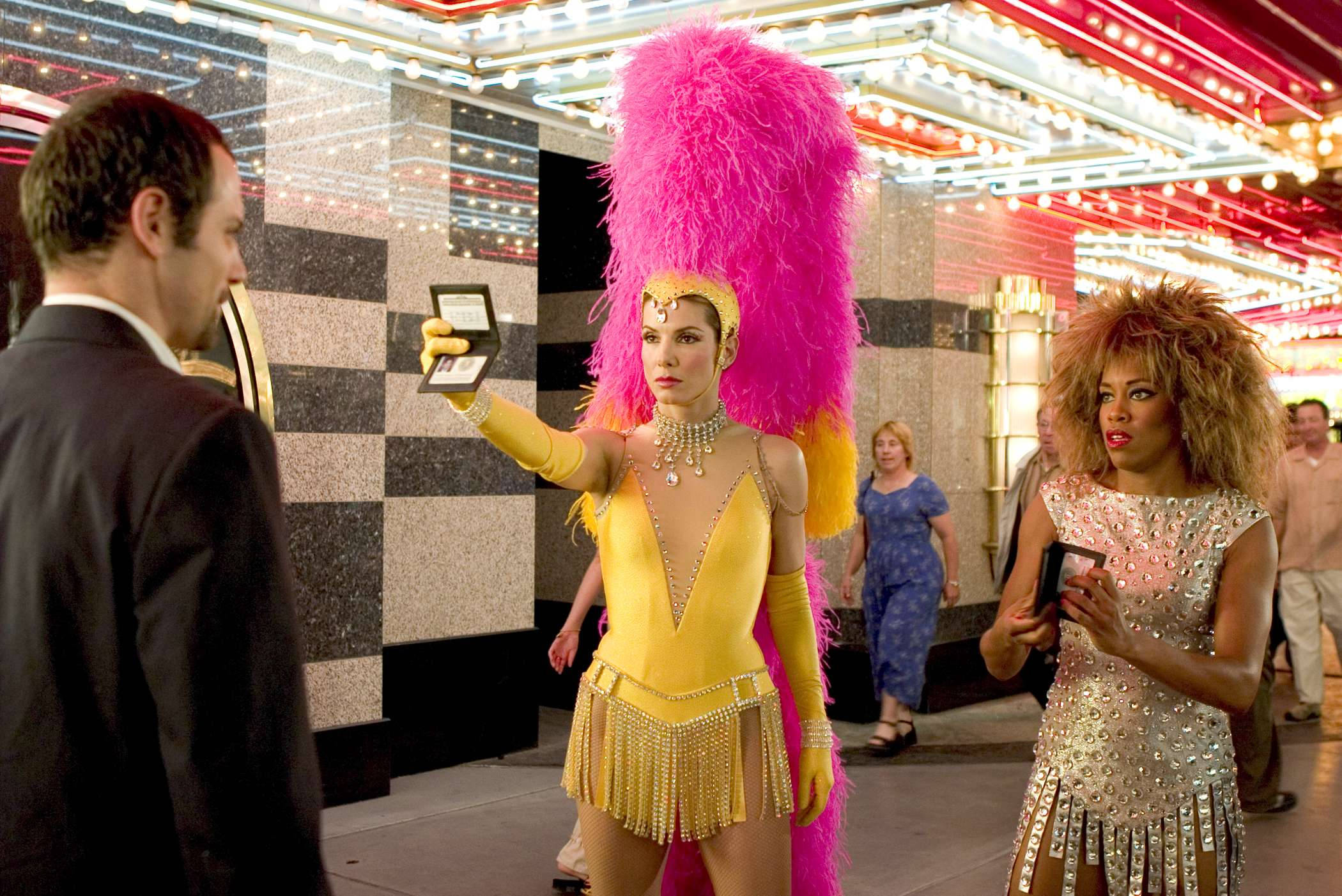 Sandra Bullock, dazzling yellow sequined outfit, towering pink feather headdress, Full HD Desktop Wallpaper