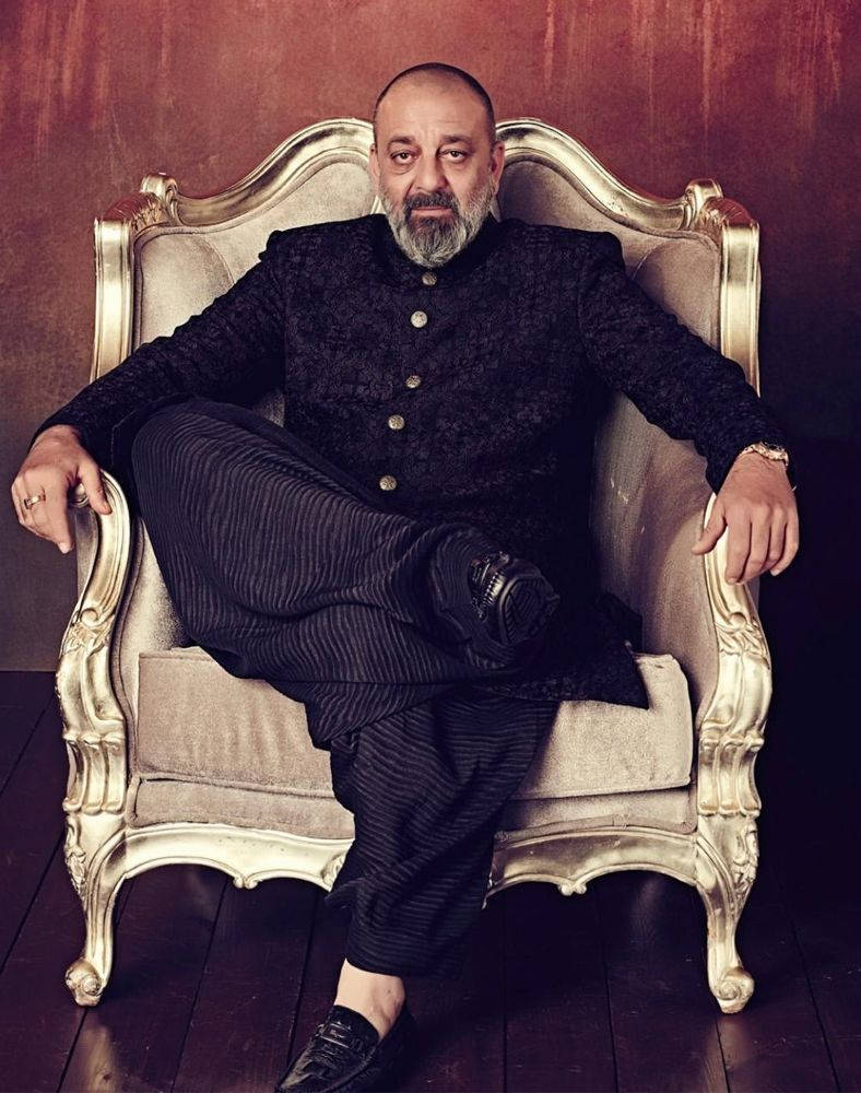 Sanjay Dutt, gold chair, rich red wall, SD Phone Wallpaper