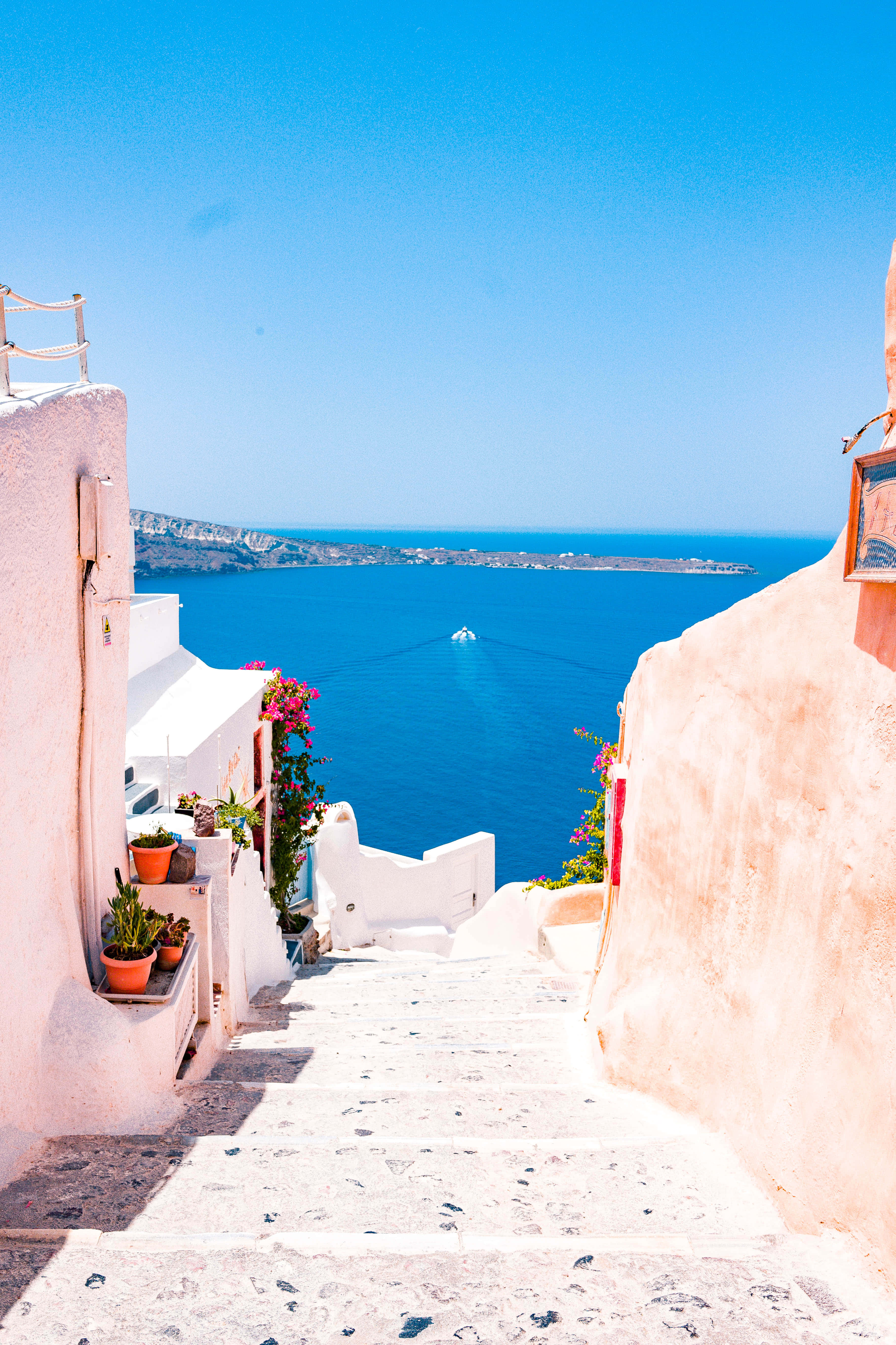 Santorini, white stone stairs, vibrant blue Aegean Sea, 5K Phone Wallpaper