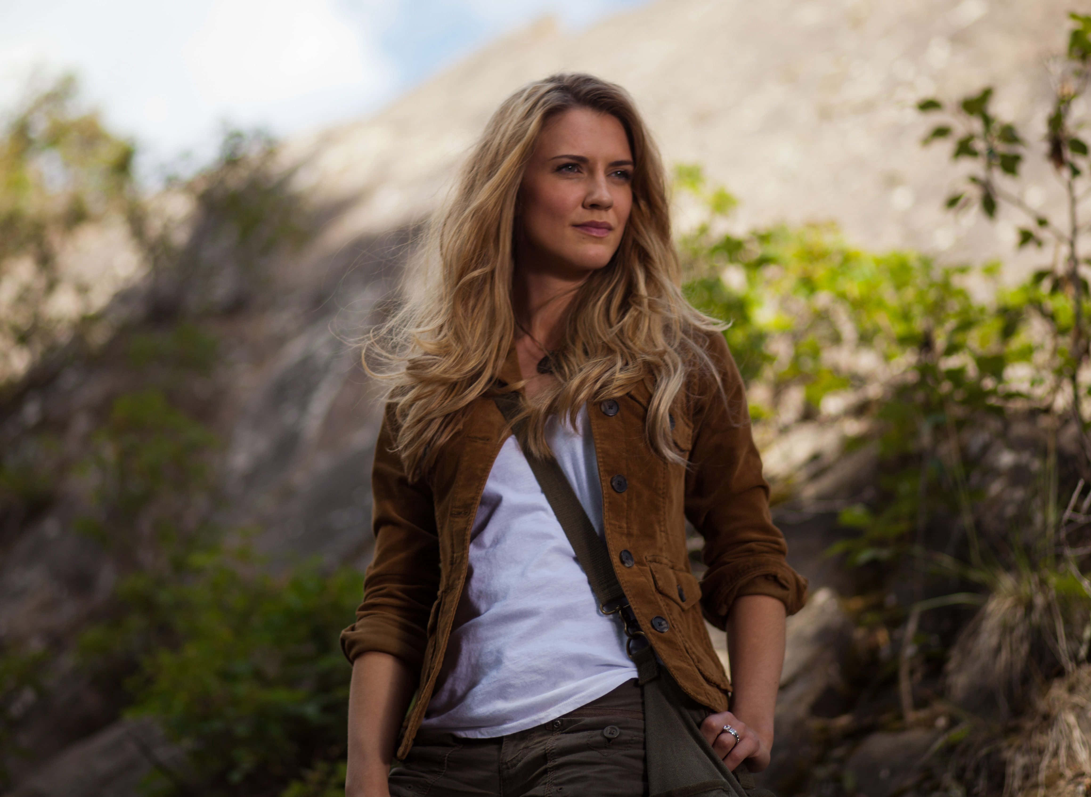 Sara Canning, brown jacket, sunlit rocky hillside, 4K Desktop Wallpaper