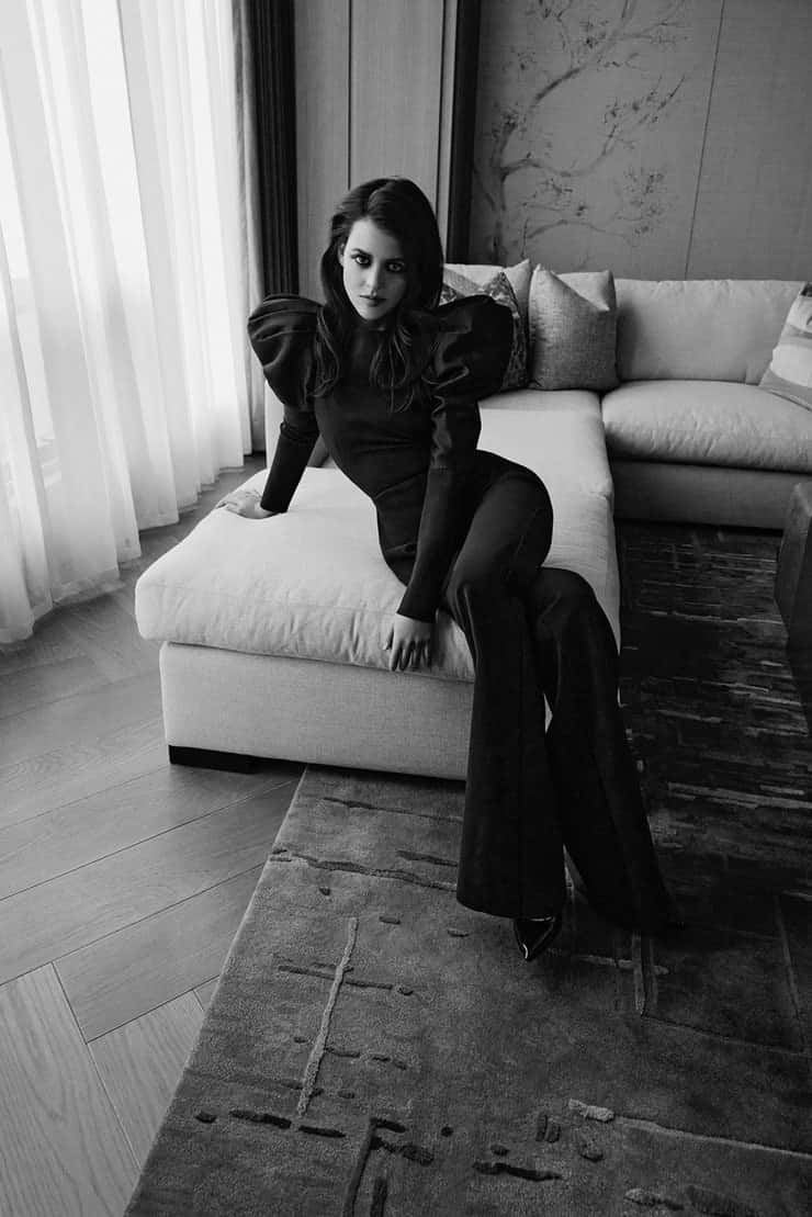 Sara Waisglass, black puffy-sleeve outfit, modern white sofa, SD Phone Wallpaper