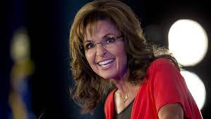 Sarah Palin, red top, dark background, SD Desktop Wallpaper