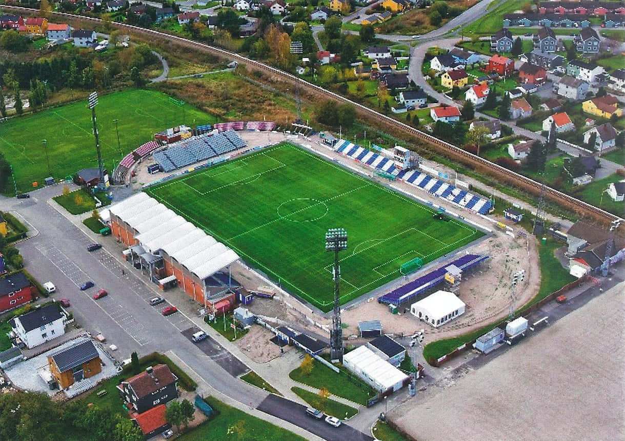 Sarpsborg, vibrant green soccer stadium, colorful houses, SD Desktop Wallpaper