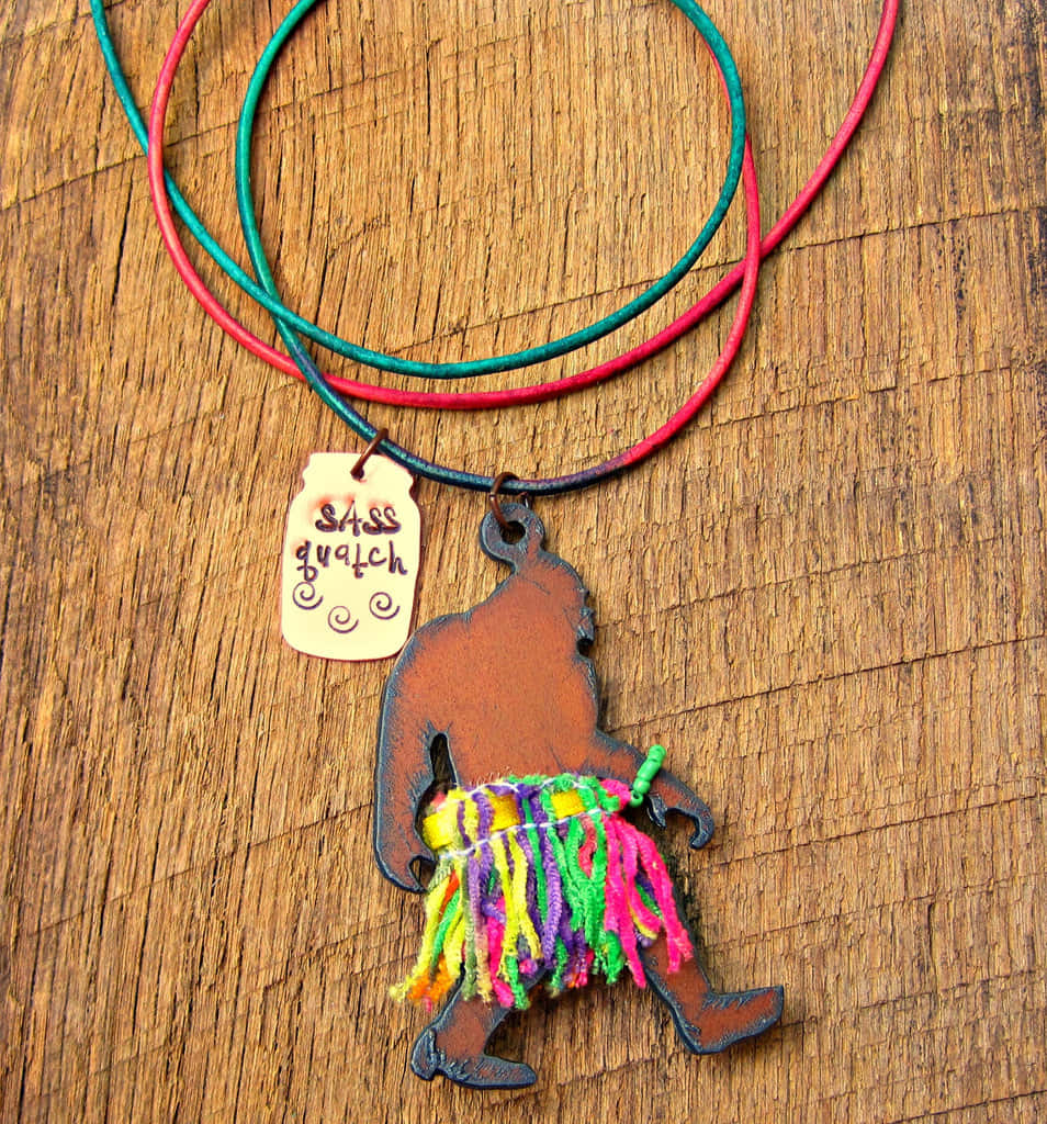 Sassy Sasquatch, colorful fringed skirt, tag reading sasquatch, SD Phone Wallpaper