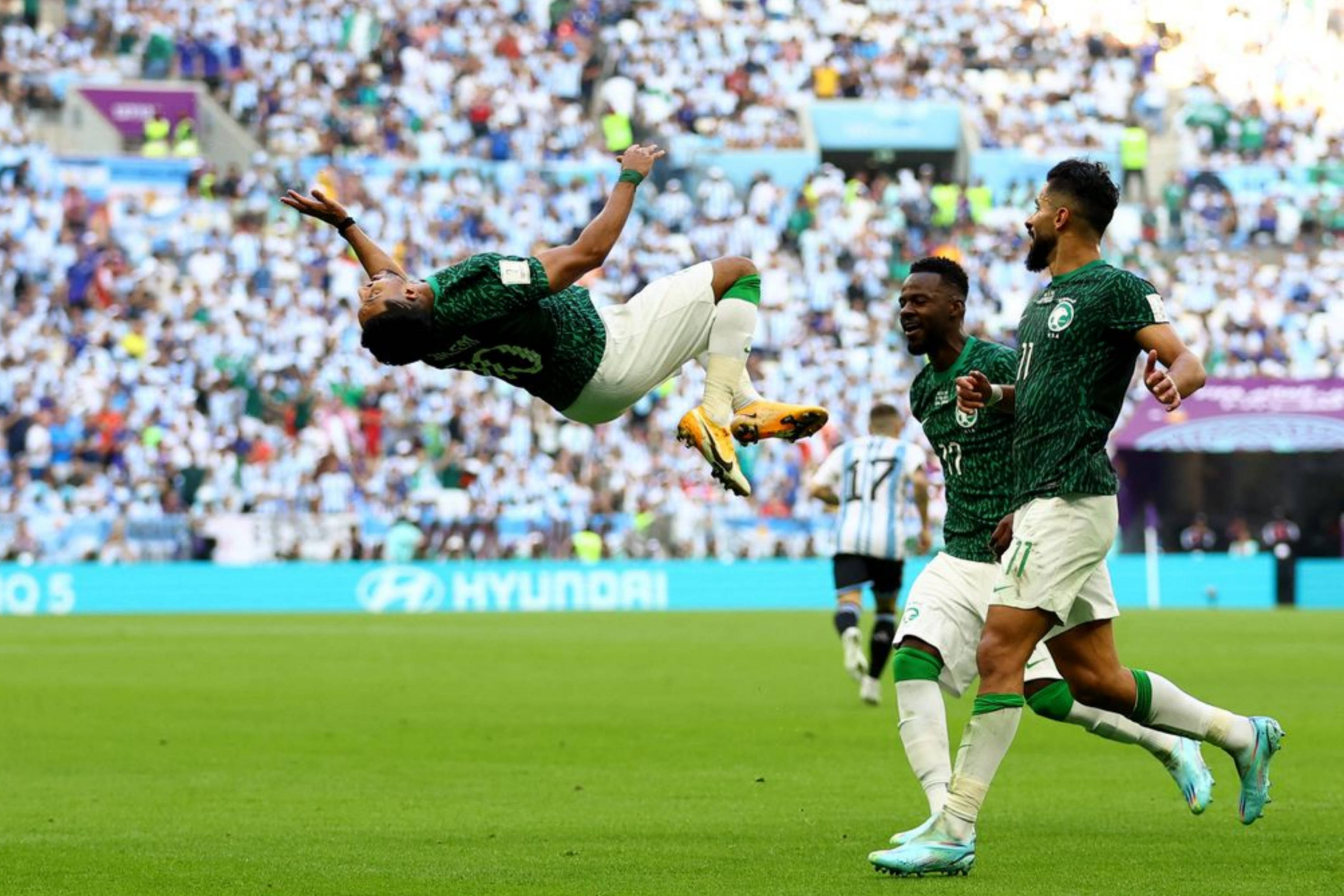 Saudi Arabia National Football Team, vibrant green pitch, packed stadium, 2K Desktop Wallpaper
