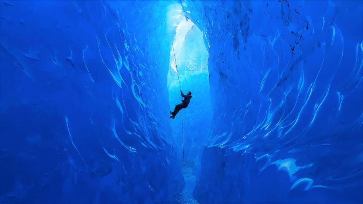 ice climbing, blue ice cave, sunlight streams through the ice ceiling, SD Desktop Wallpaper