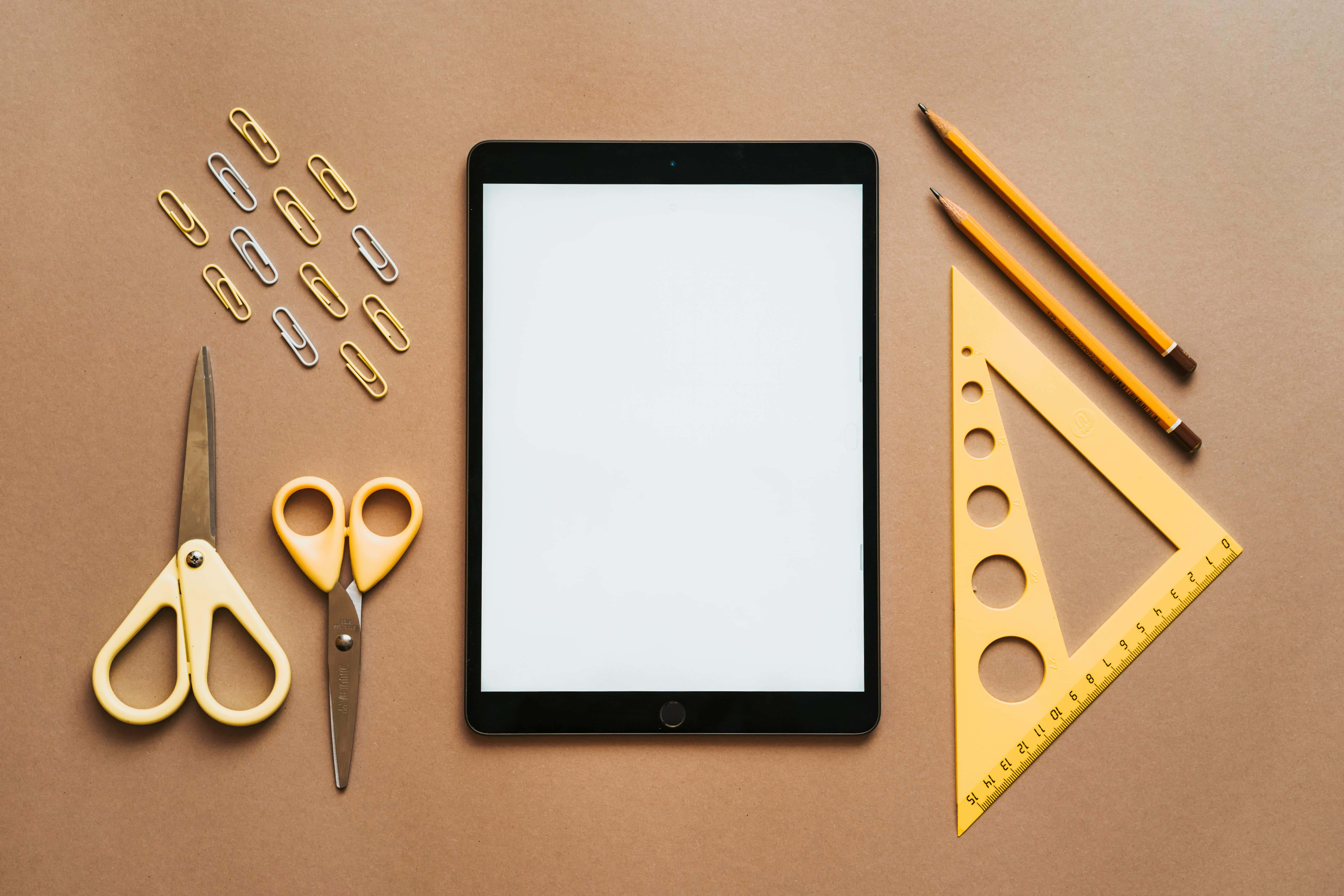 yellow stationery tools, blank tablet, warm brown paper background, 5K Desktop Wallpaper