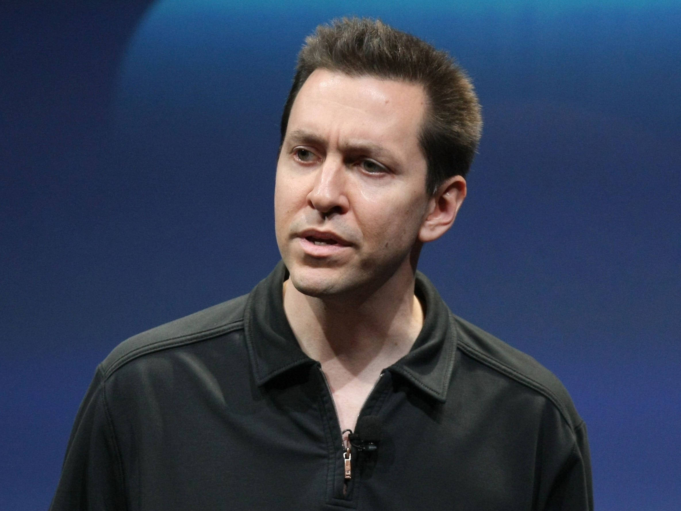 Scott Forstall, black zip-neck shirt, solid blue background, Full HD Desktop Wallpaper