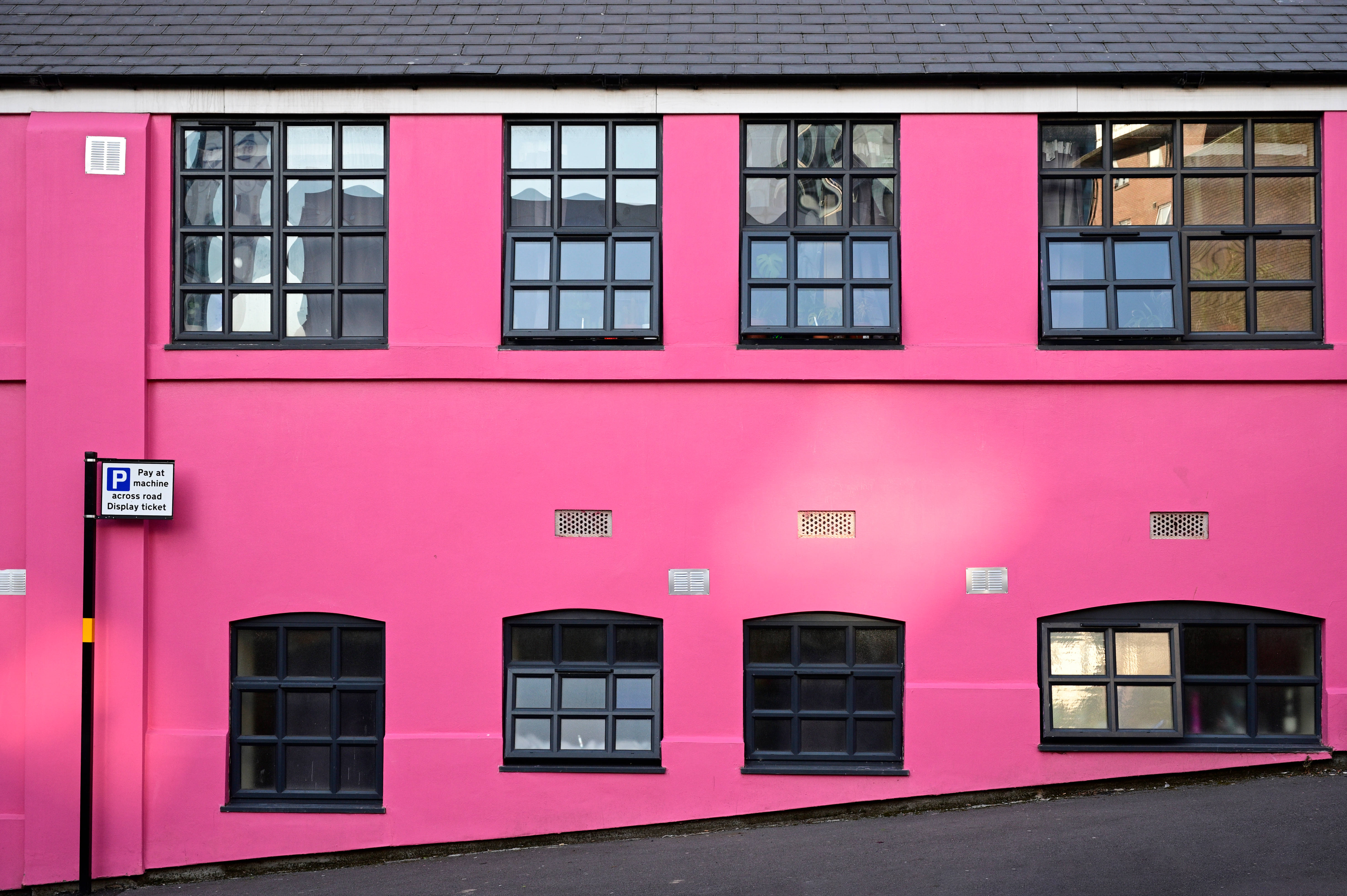 hot pink building, black-framed windows, daylight, 5K Desktop Wallpaper