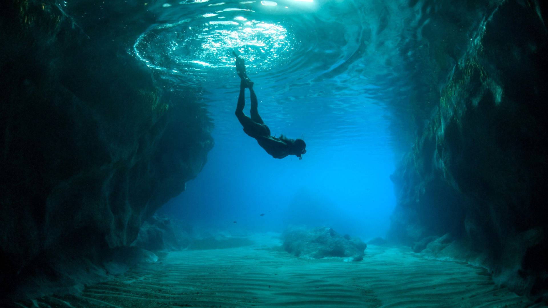 woman diving, sunlit underwater cave, rippling blue water, Full HD Desktop Wallpaper