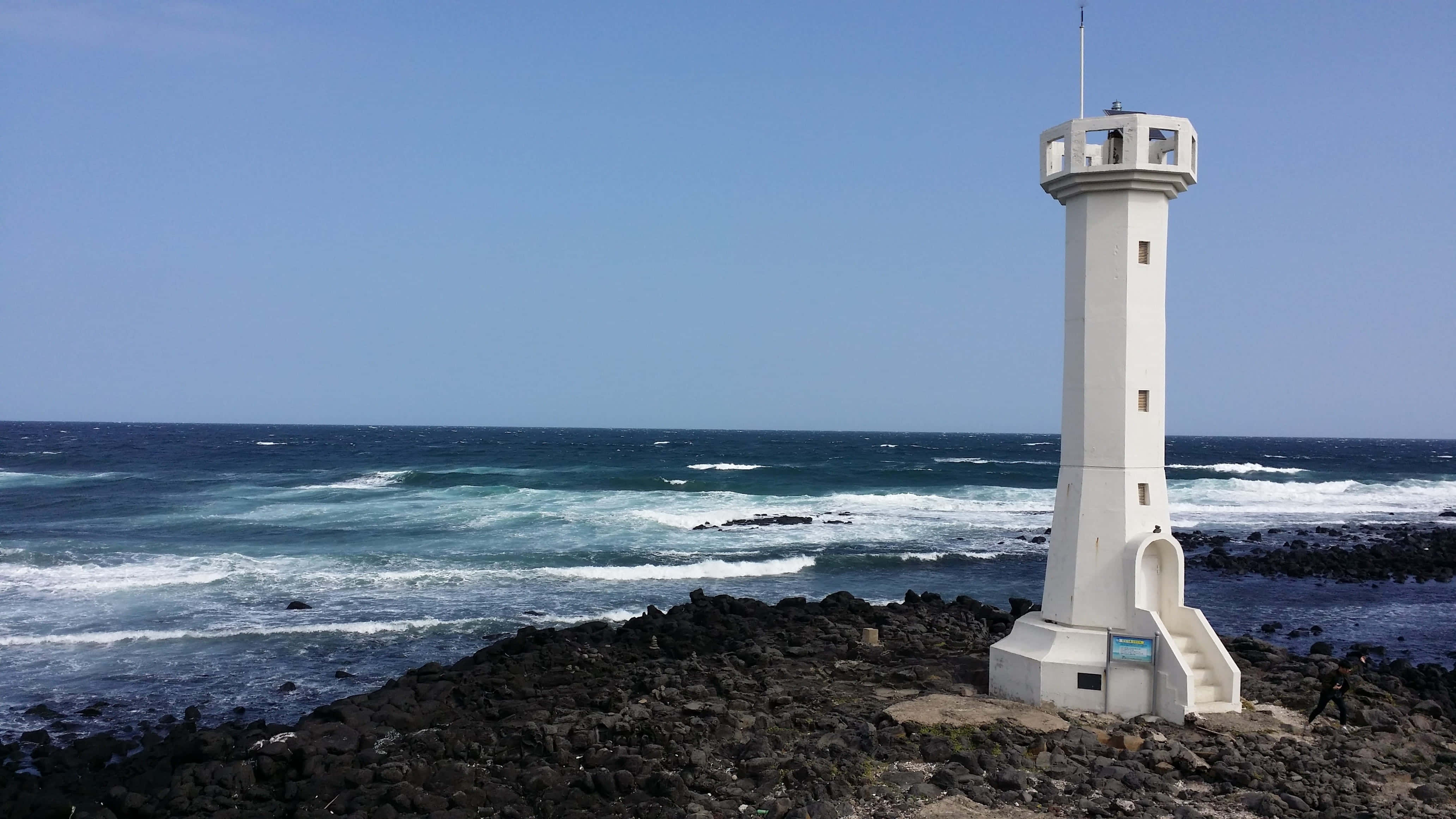 Sea Breeze, white lighthouse, rugged black lava rock coastline, 4K Desktop Wallpaper
