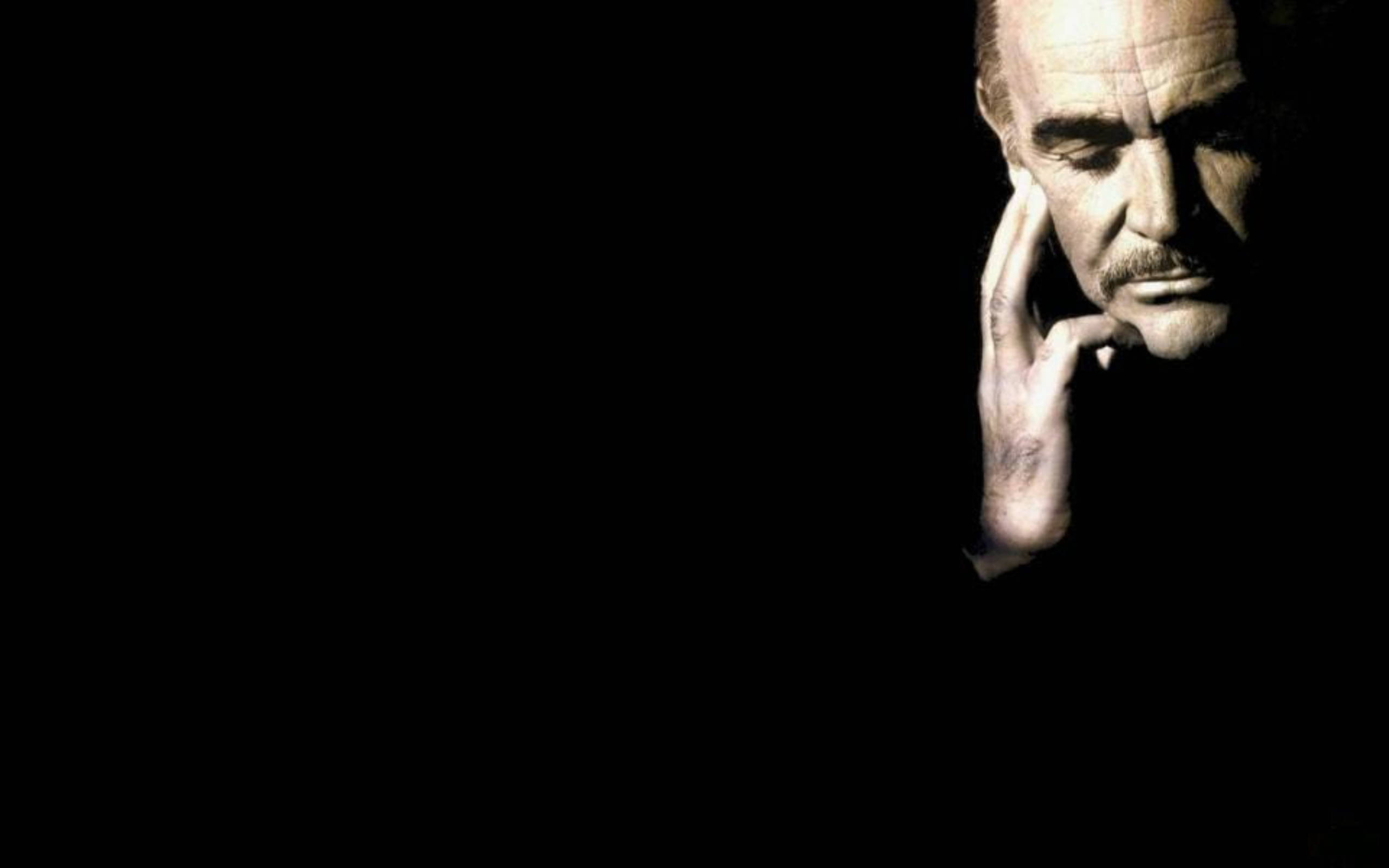 Sean Connery, contemplative pose, dramatic spotlight, 2K Desktop Wallpaper