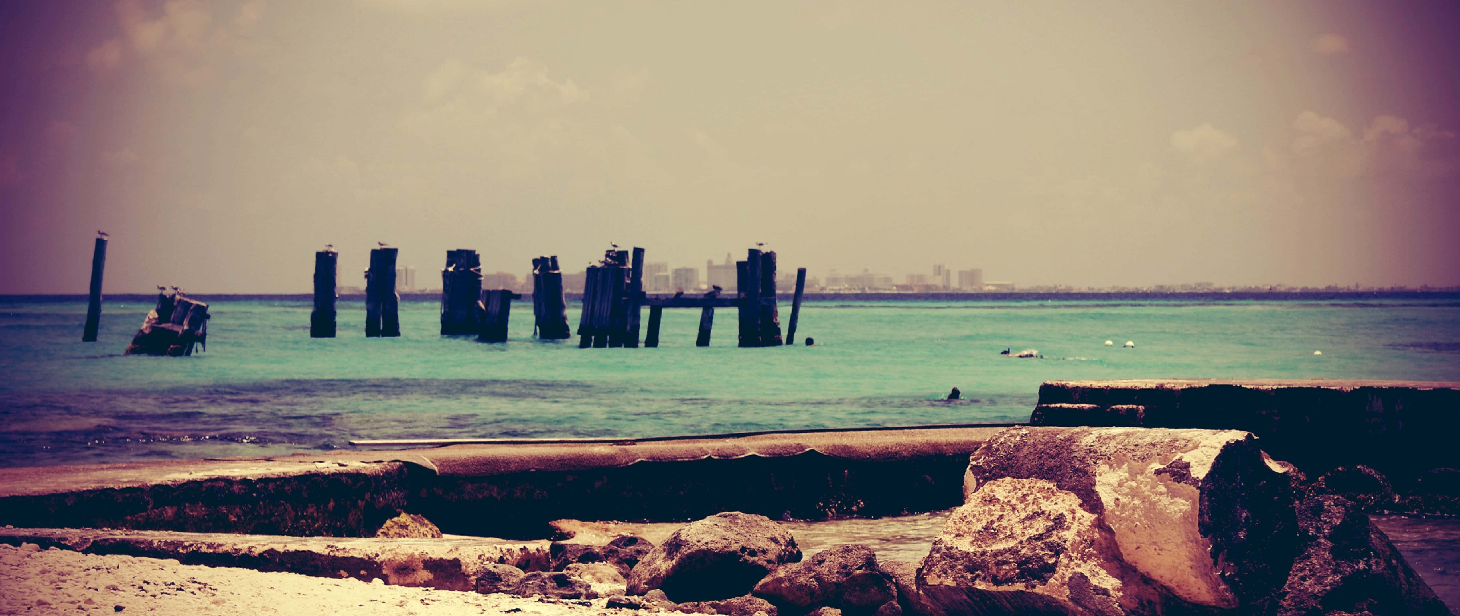 retro beach, wooden pier pilings, turquoise water, 5K Desktop Wallpaper