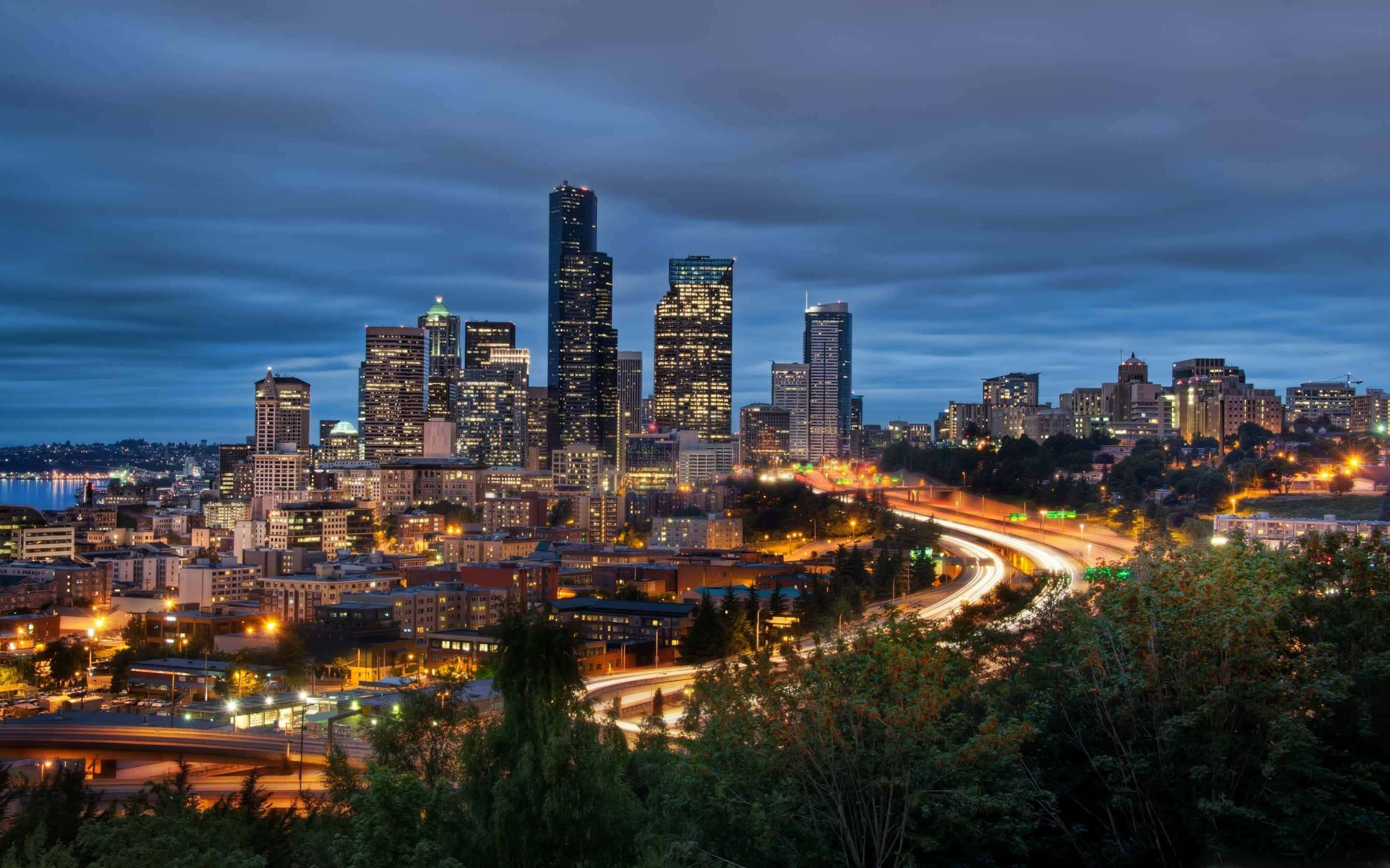 Seattle skyline, dusk, glowing skyscrapers, 2K Desktop Wallpaper