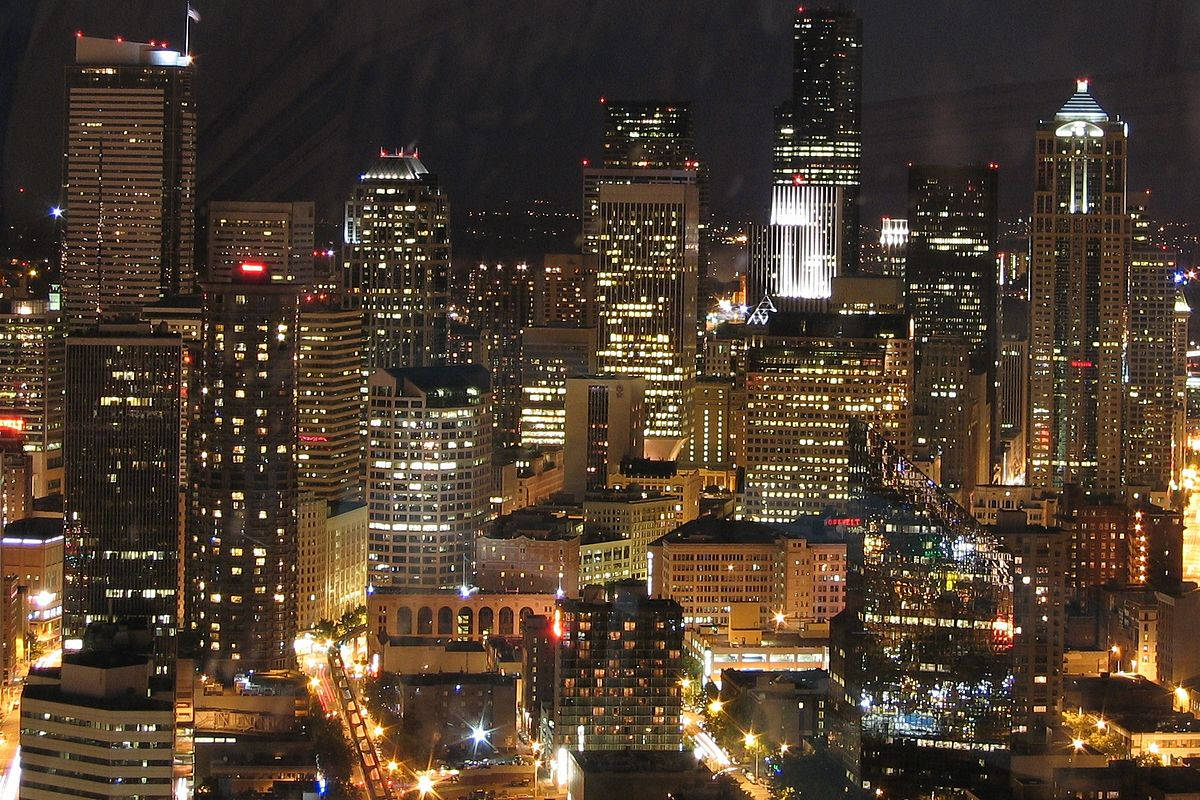 Seattle skyline, towering skyscrapers, warm golden lights, SD Desktop Wallpaper