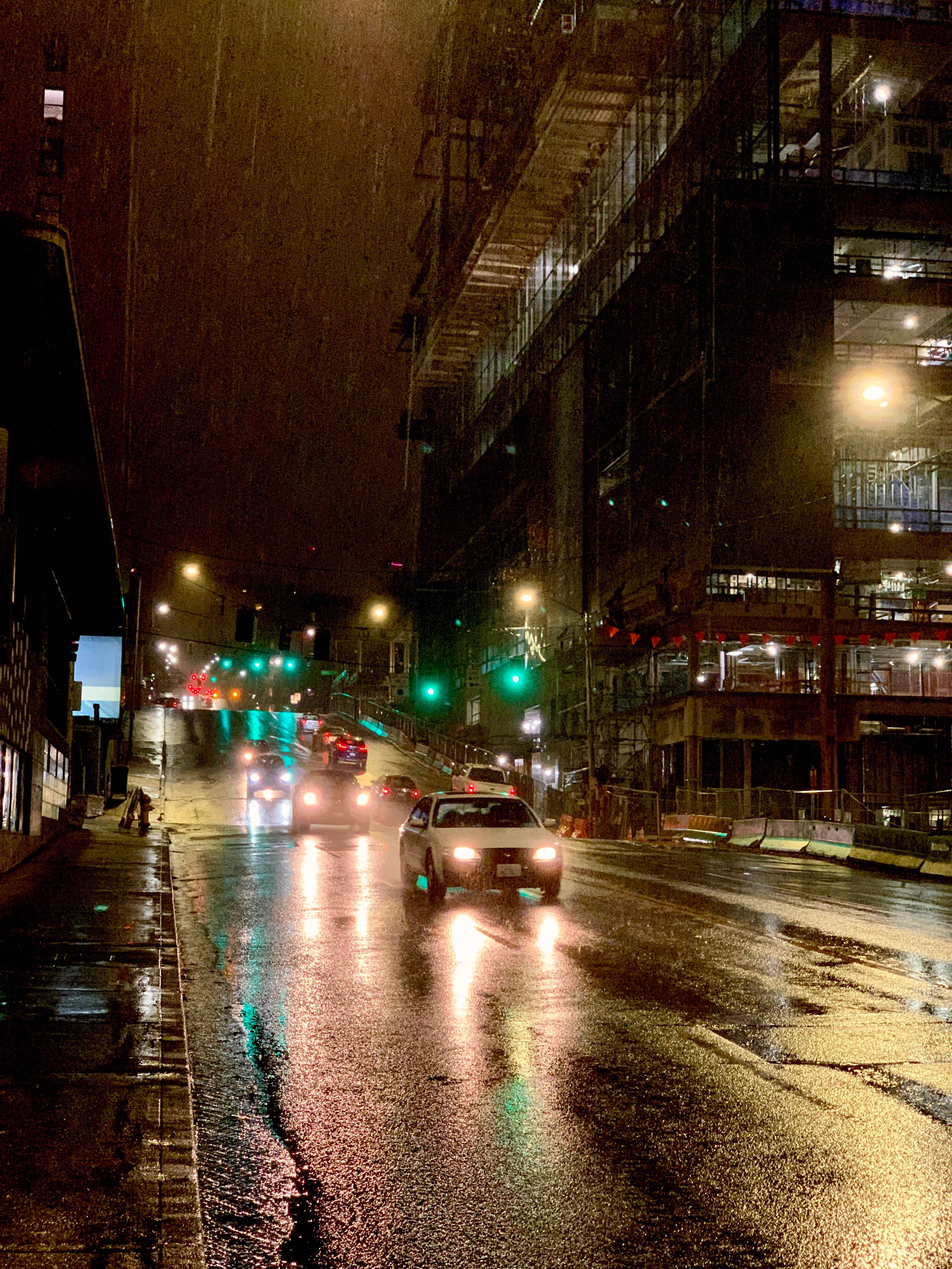 Seattle Rain, rain-slicked city street, glowing car headlights, 4K Phone Wallpaper