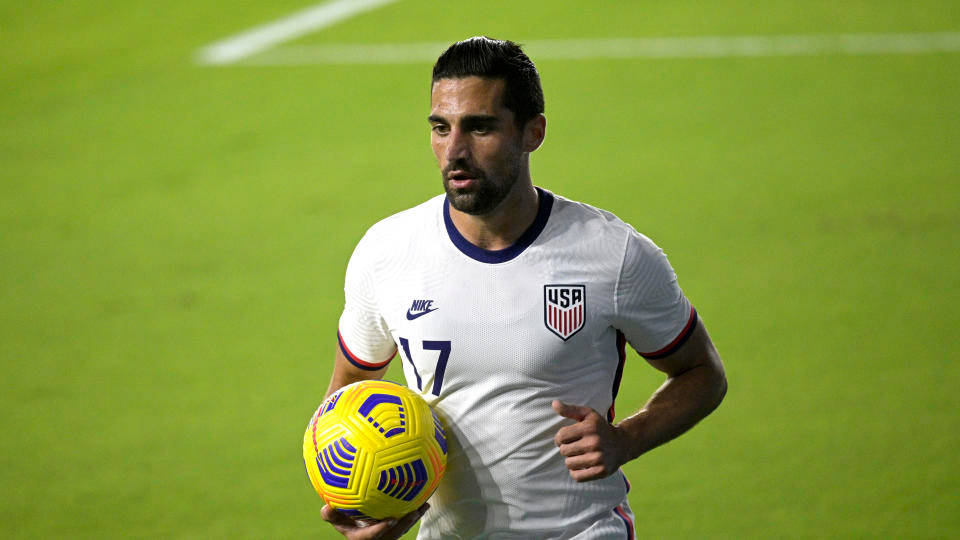 Sebastian Lletget, white USA jersey, vibrant yellow and blue soccer ball, SD Desktop Wallpaper