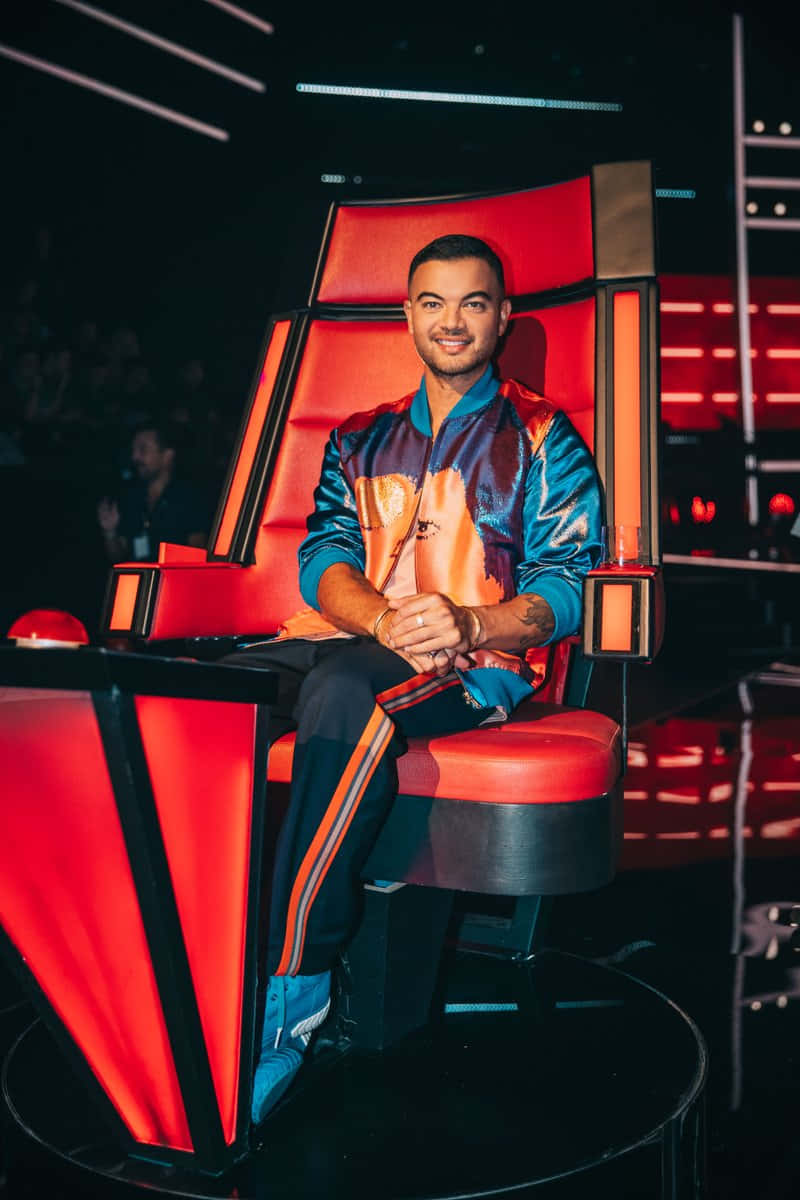 Guy Sebastian, shiny blue and orange jacket, glowing red judge's chair, SD Phone Wallpaper