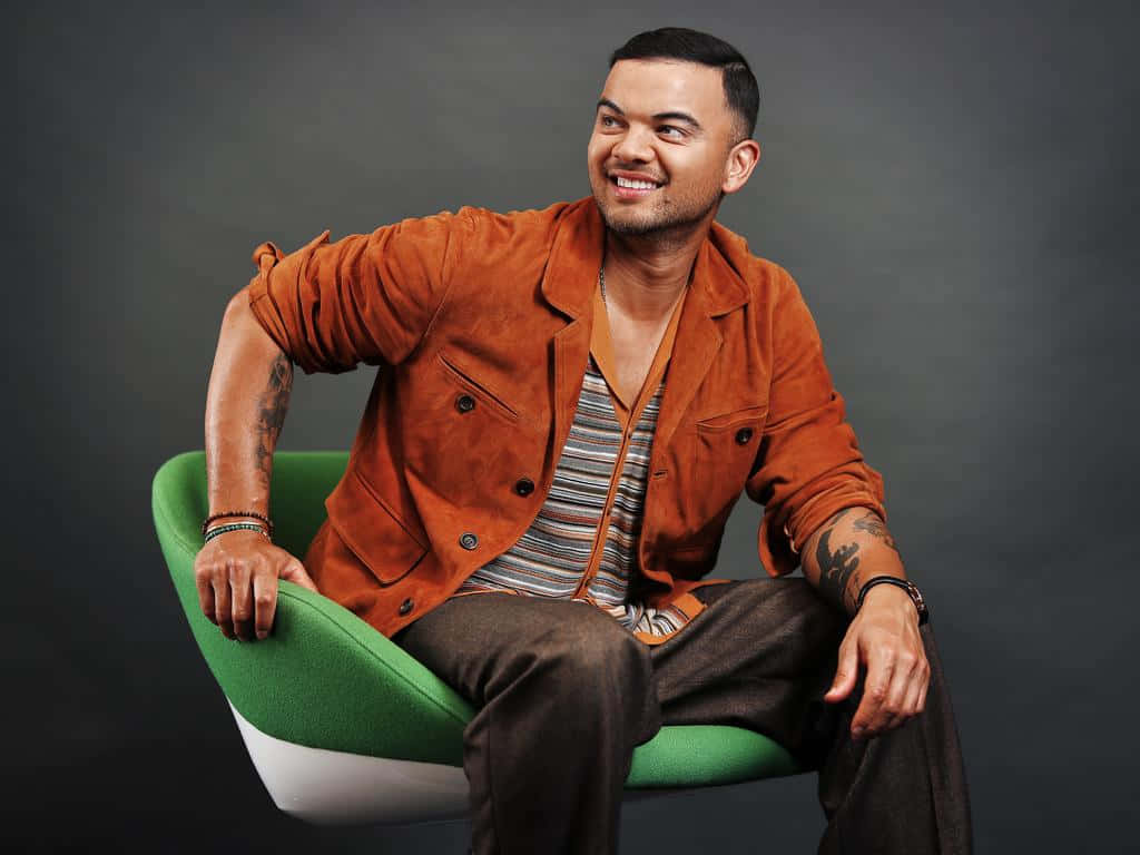 Guy Sebastian, vibrant green chair, dark gray studio backdrop, SD Desktop Wallpaper