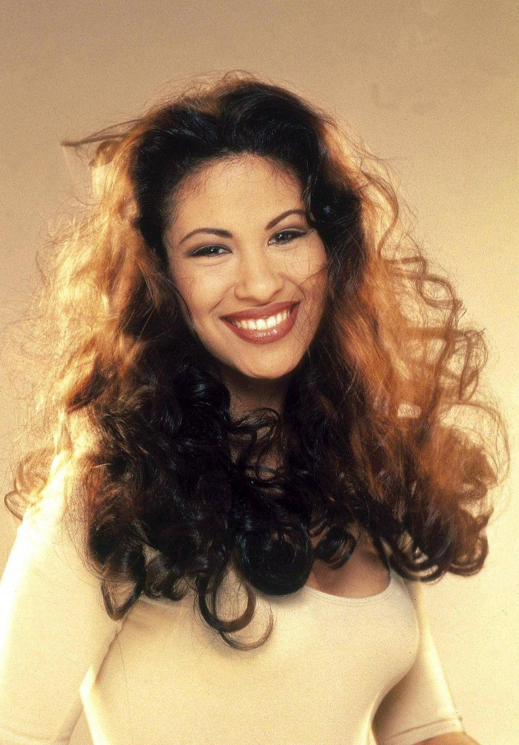 Selena Quintanilla, voluminous curly hair, soft beige studio backdrop, HD Phone Wallpaper