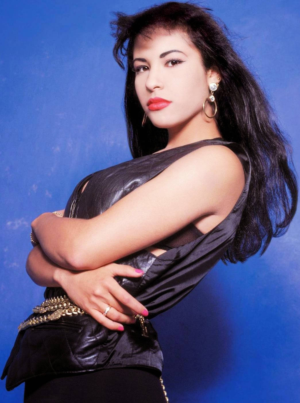 Selena Quintanilla, black leather top, vibrant blue studio backdrop, HD Phone Wallpaper