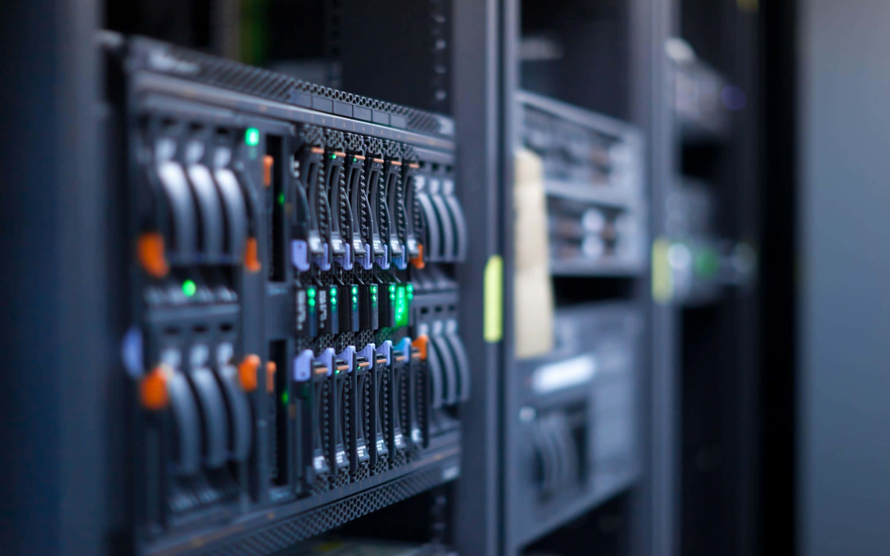 data center, server rack, glowing green indicator lights, 2K Desktop Wallpaper
