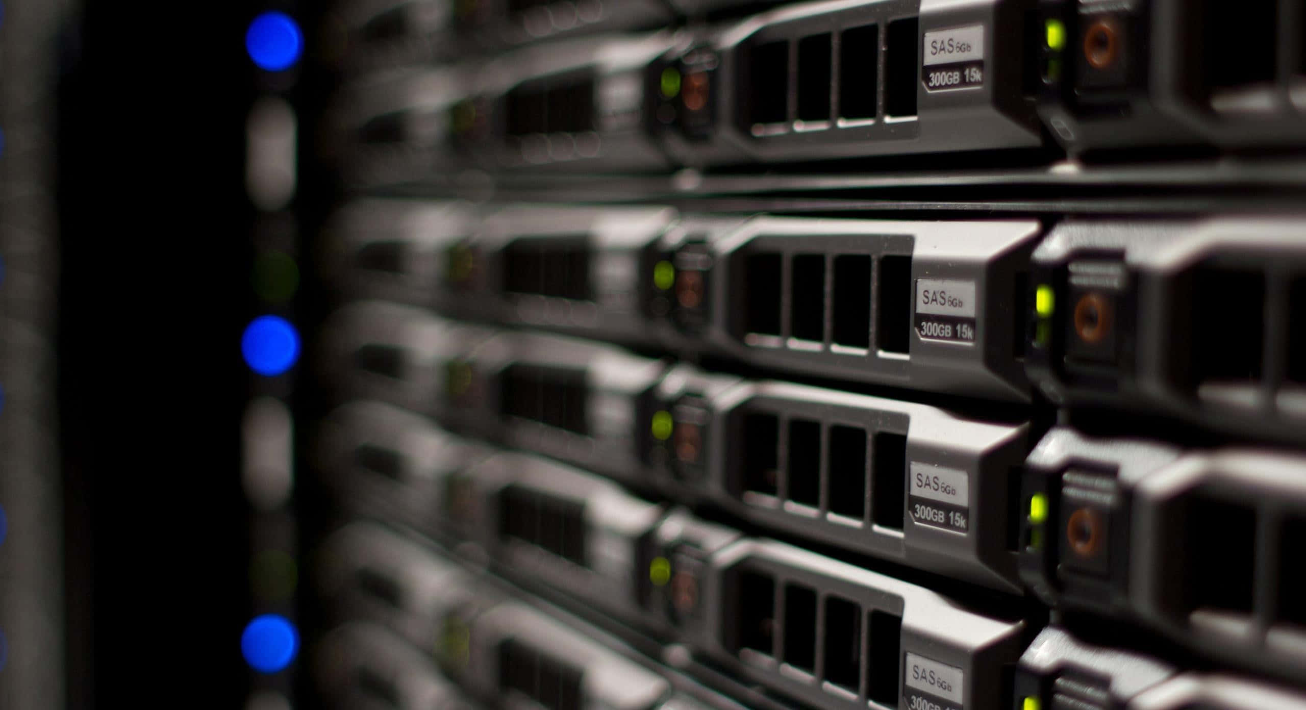server rack, glowing blue and green indicator lights, dimly lit data center, 2K Desktop Wallpaper