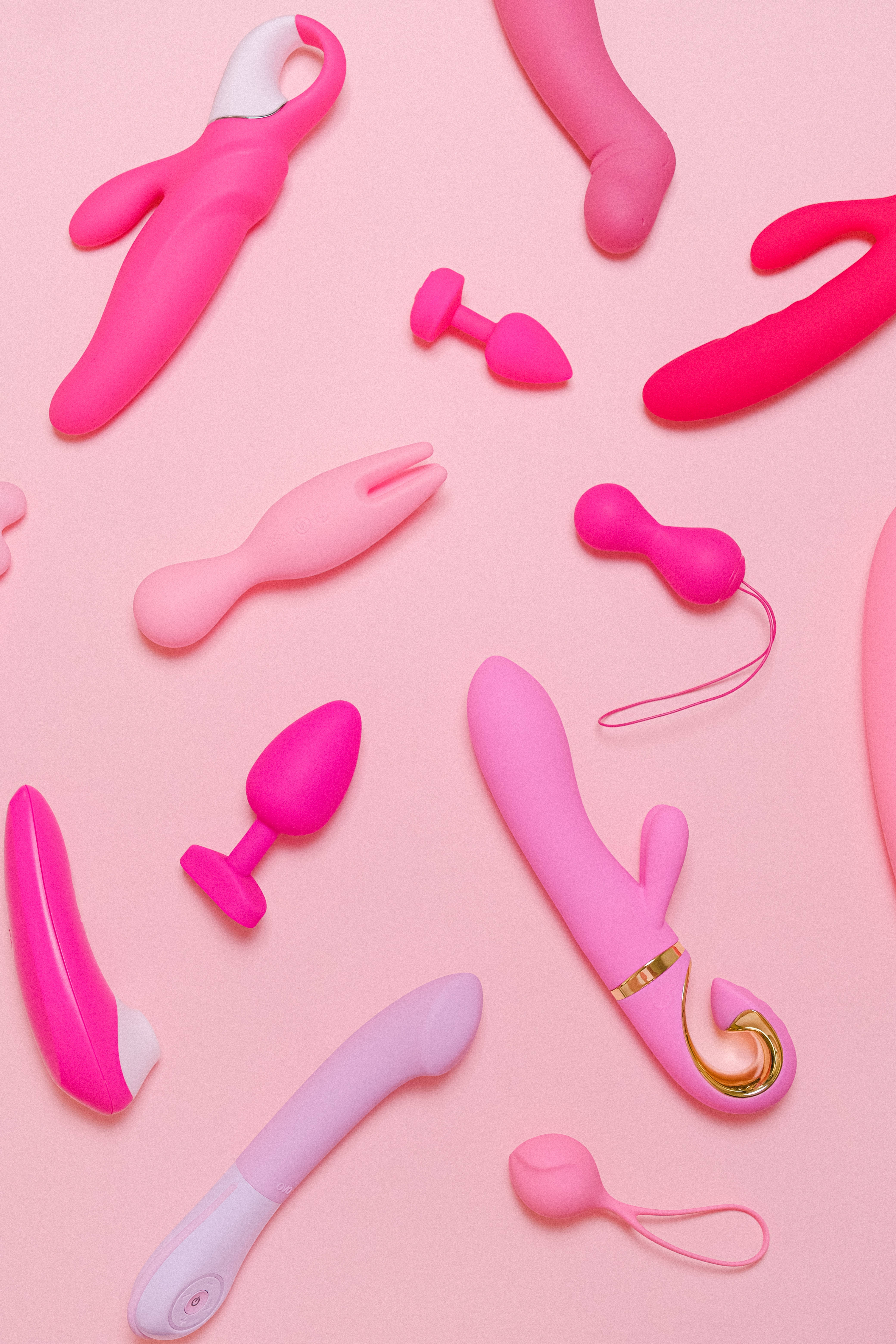 pink silicone sex toys, soft pink background, flat lay composition, 5K Phone Wallpaper