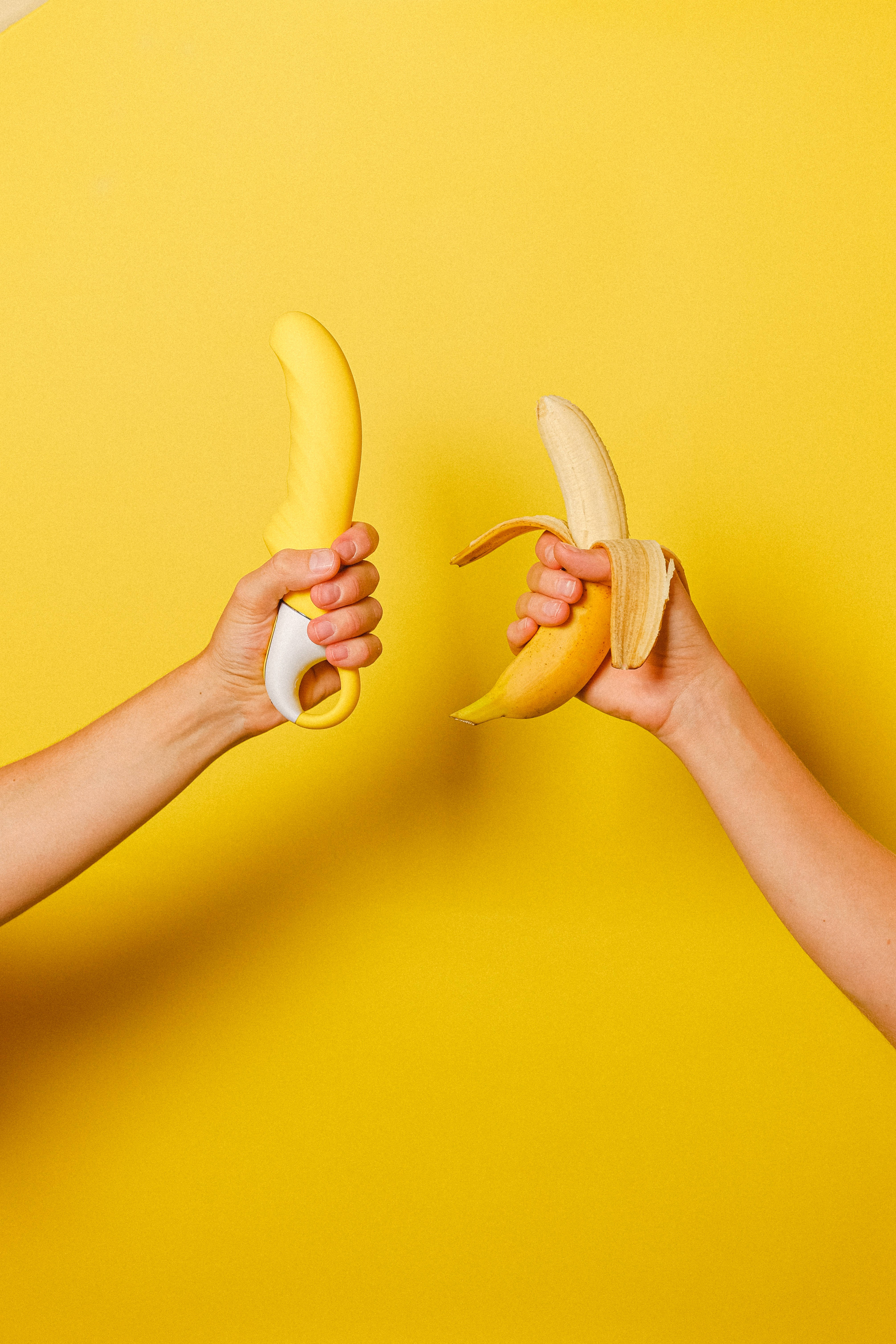 banana, banana-shaped vibrator, solid yellow background, 5K Phone Wallpaper