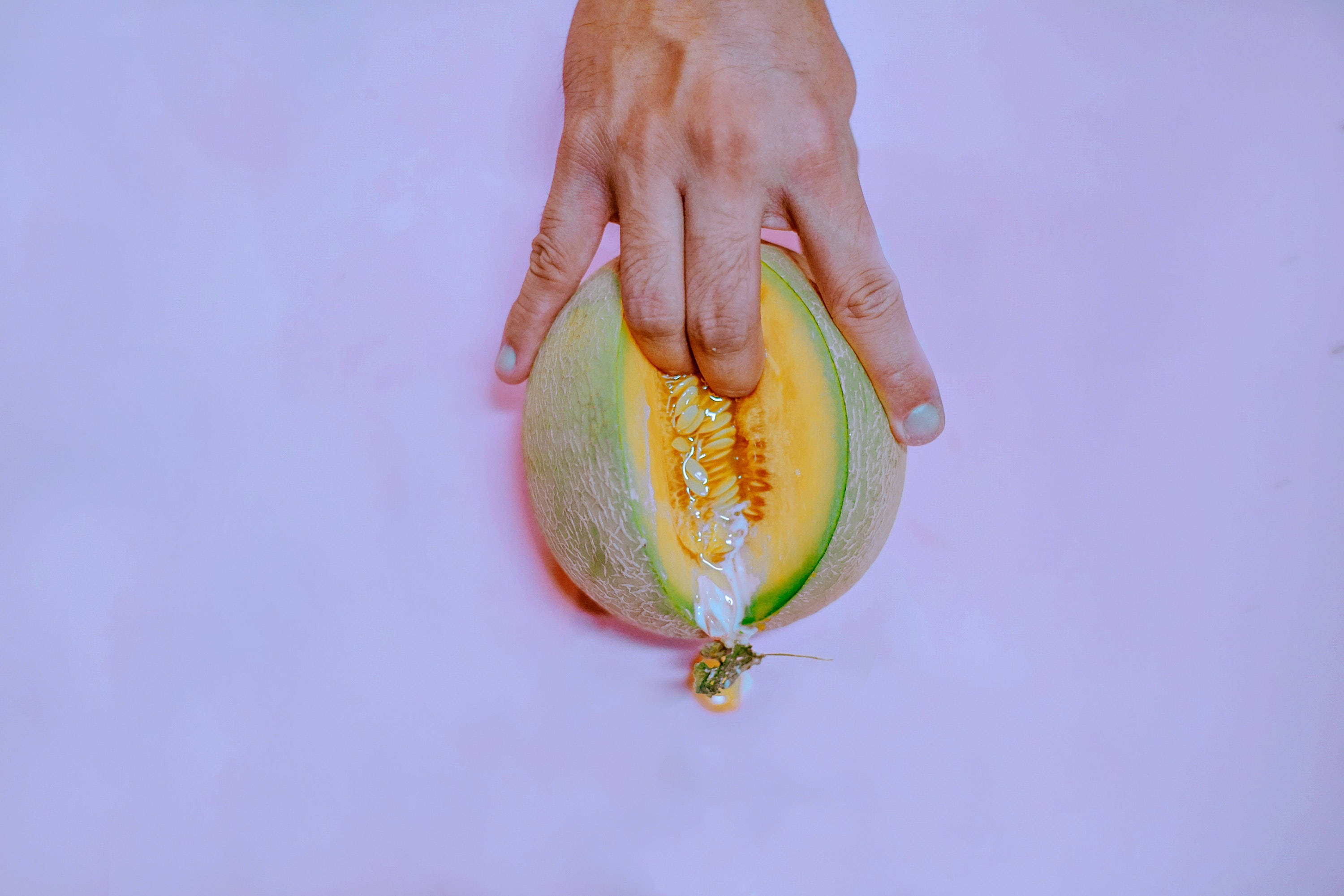 cantaloupe, juicy orange flesh, soft purple background, 2K Desktop Wallpaper