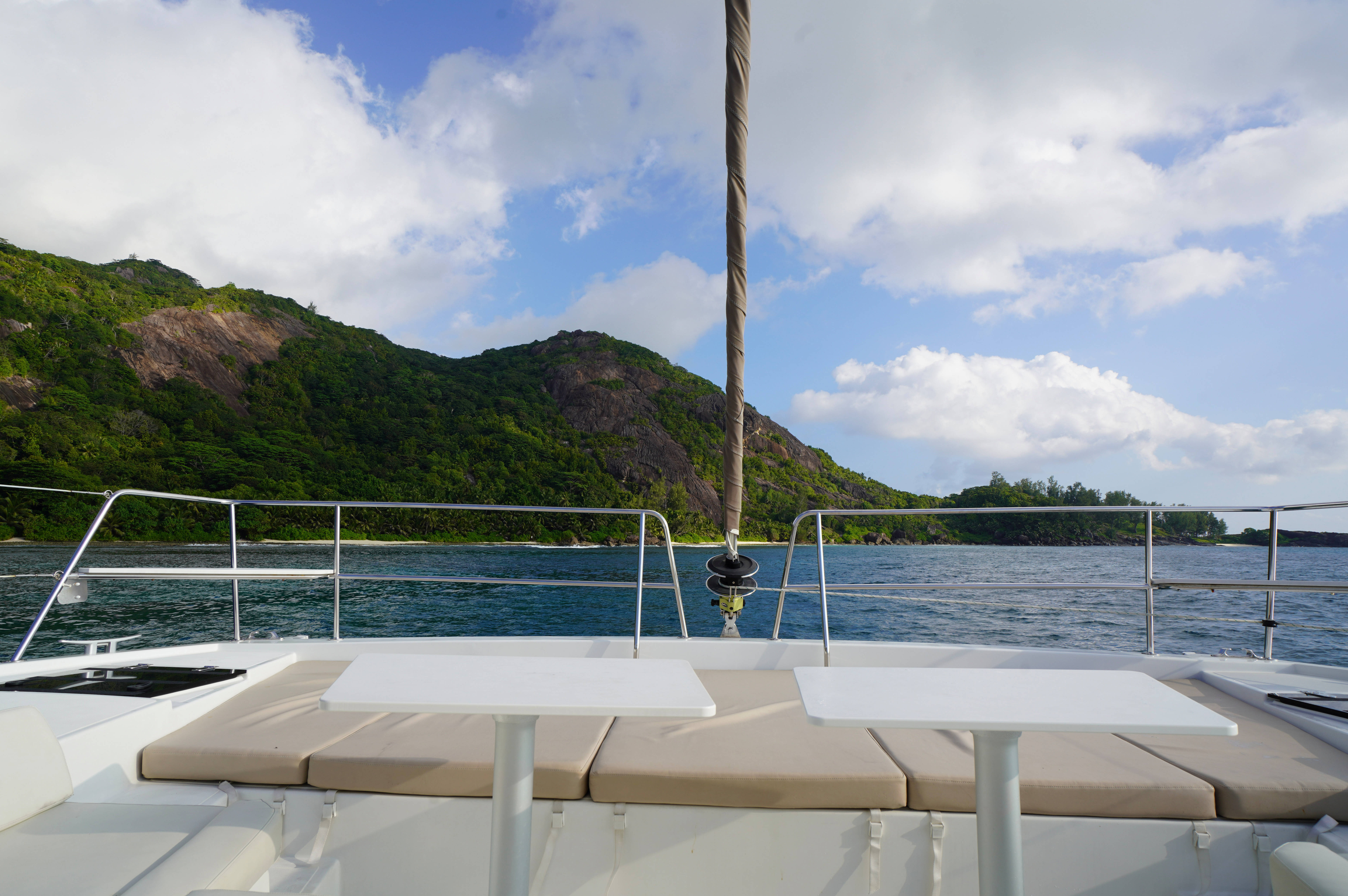 Seychelles, white catamaran deck, beige cushions, 5K Desktop Wallpaper