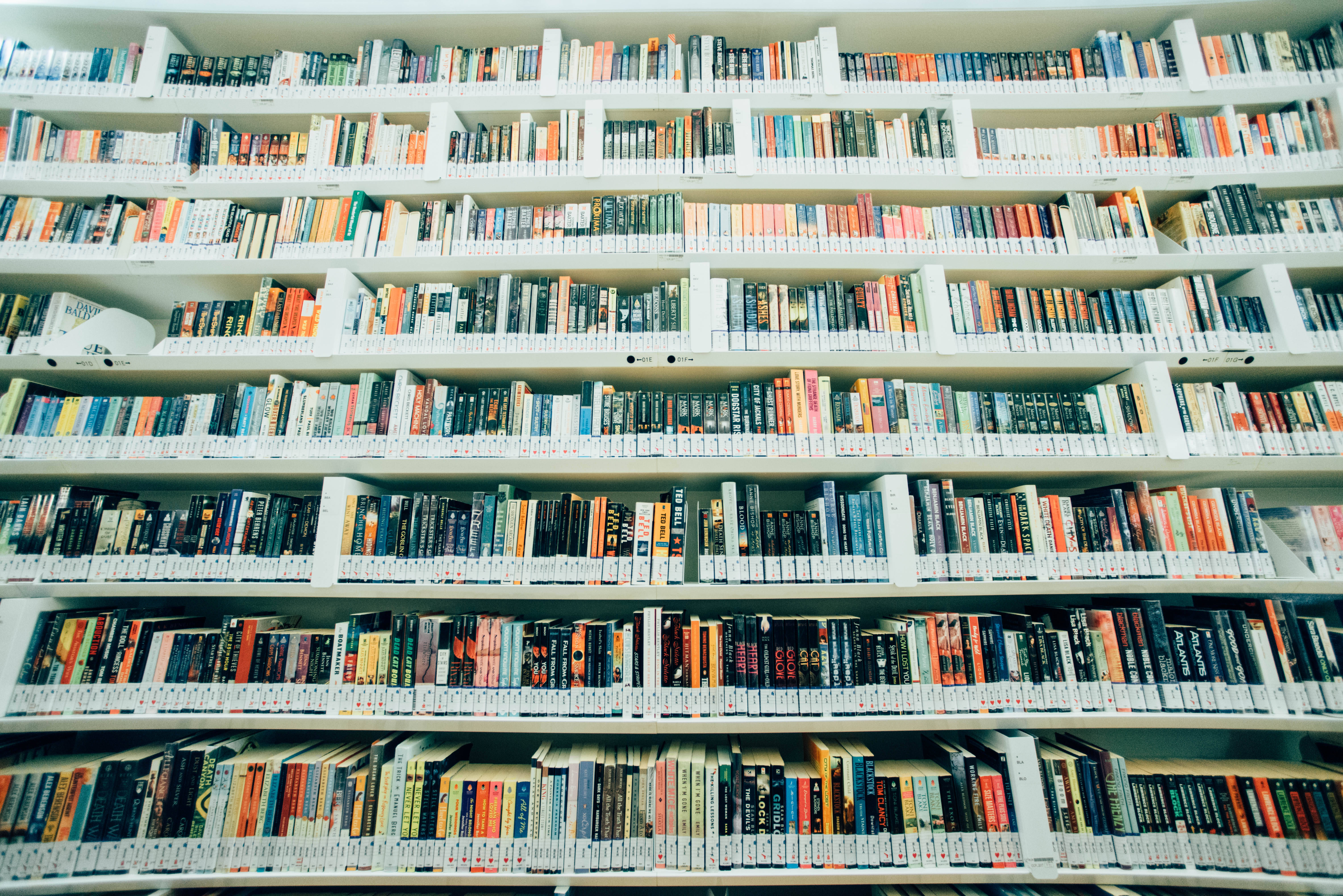 white bookshelves, colorful books, library aisle, 5K Desktop Wallpaper