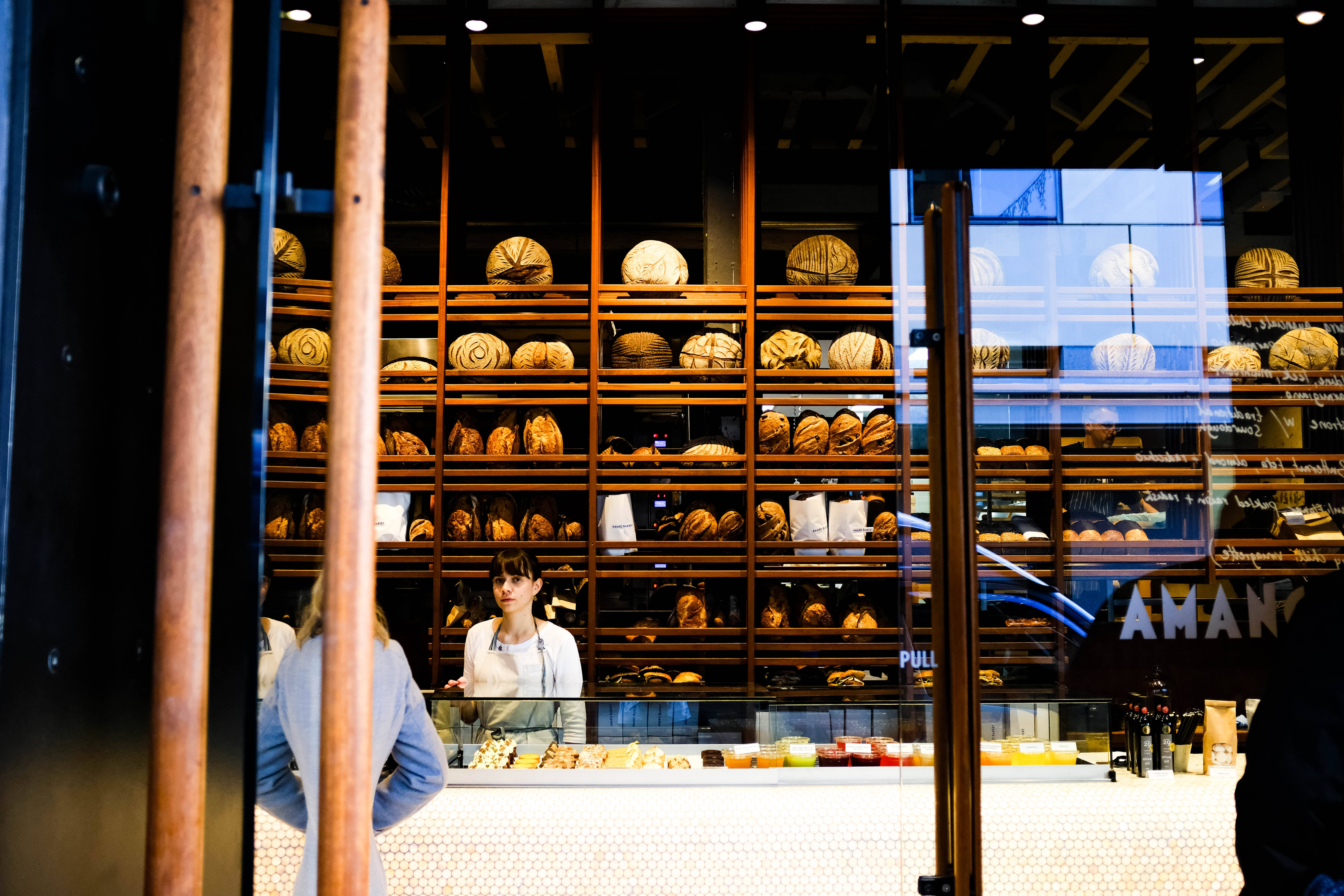 bakery display case, golden loaves of bread, glass, 5K Desktop Wallpaper