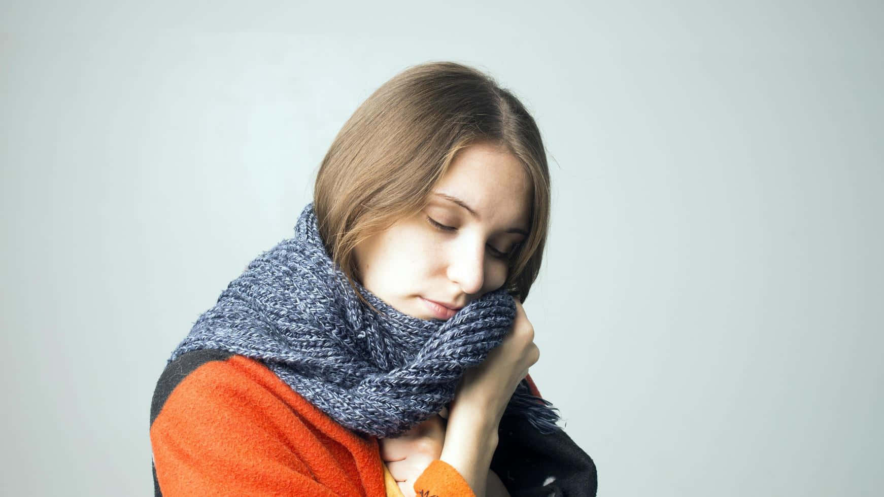 Shivering Woman Holding Scarf, gray knitted scarf, orange sweater, HD Desktop Wallpaper