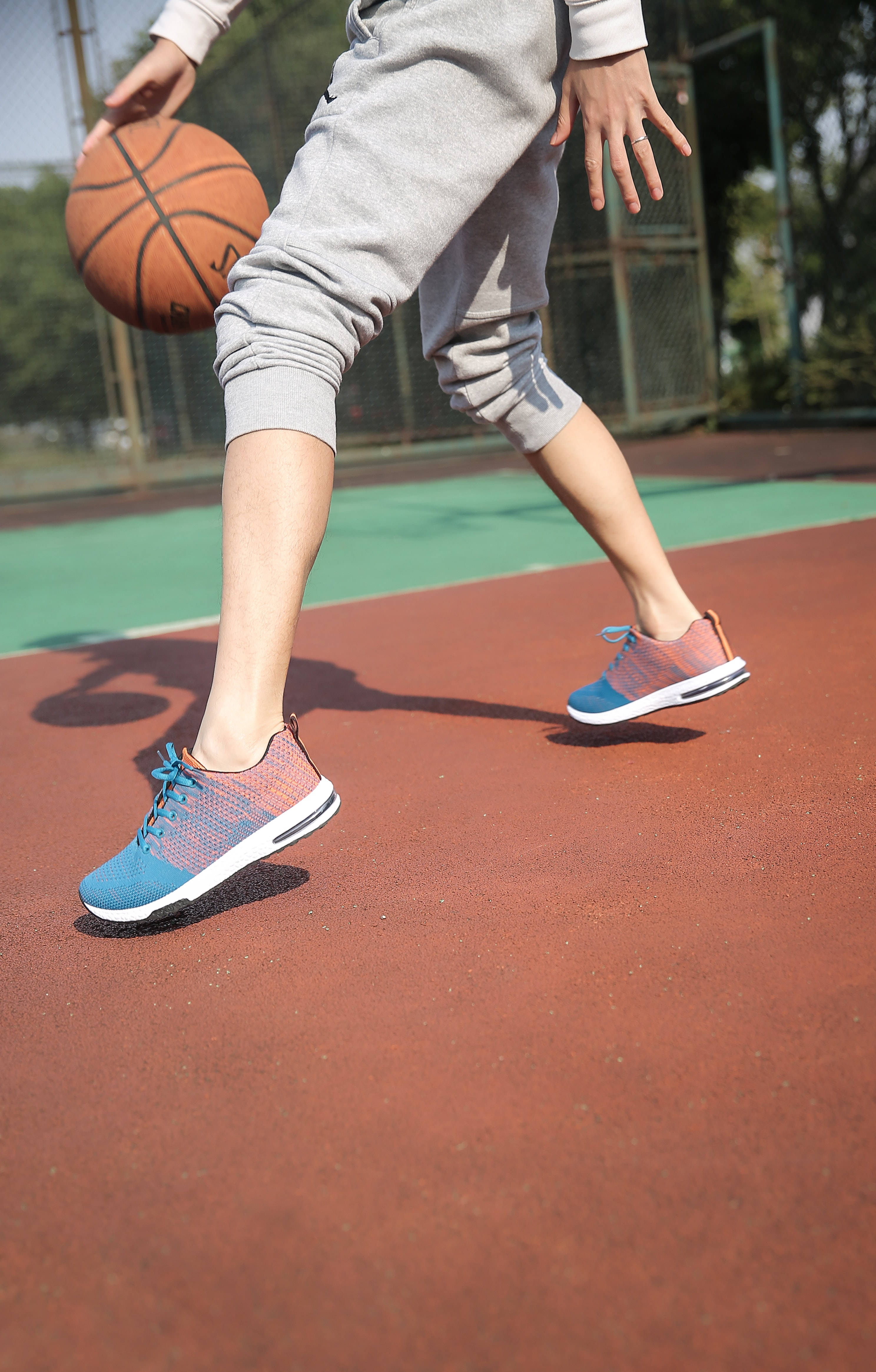 green and orange basketball shoes, red outdoor court, bright daylight, 4K Phone Wallpaper