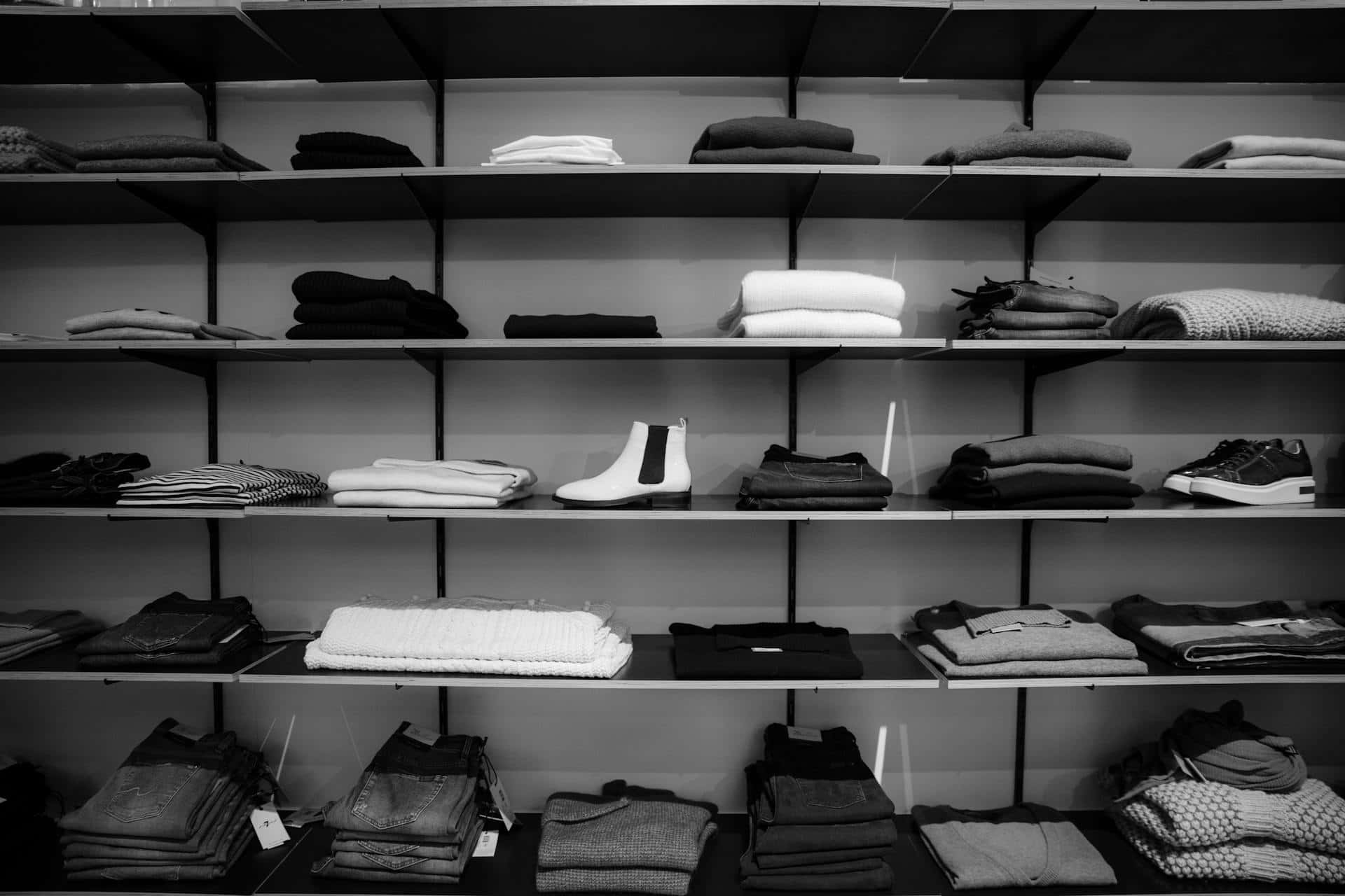 monochrome clothing store display, black and white photo, neatly folded clothes, Full HD Desktop Wallpaper