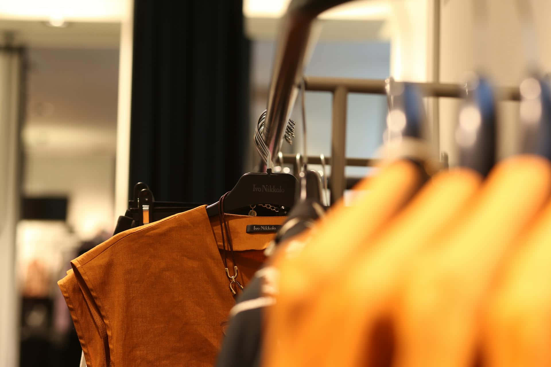 mustard orange linen shirt, branded hanger, warmly lit boutique rack, Full HD Desktop Wallpaper