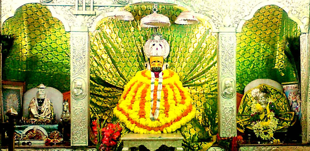 Shyam Baba, yellow and orange floral garlands, ornate white canopies, SD Desktop Wallpaper