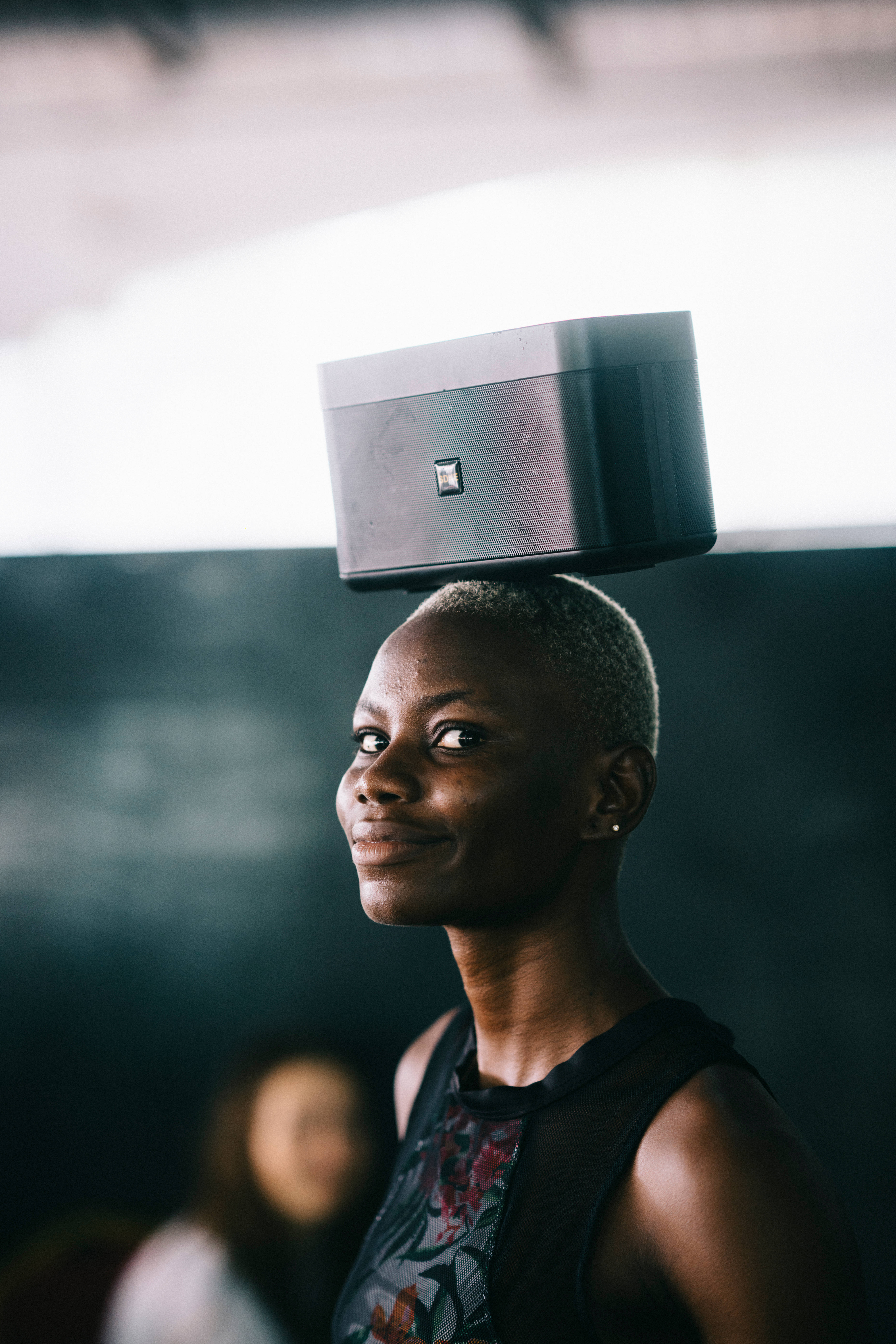 Sierra Leone, sleek black speaker, shaved head, 8K Phone Wallpaper