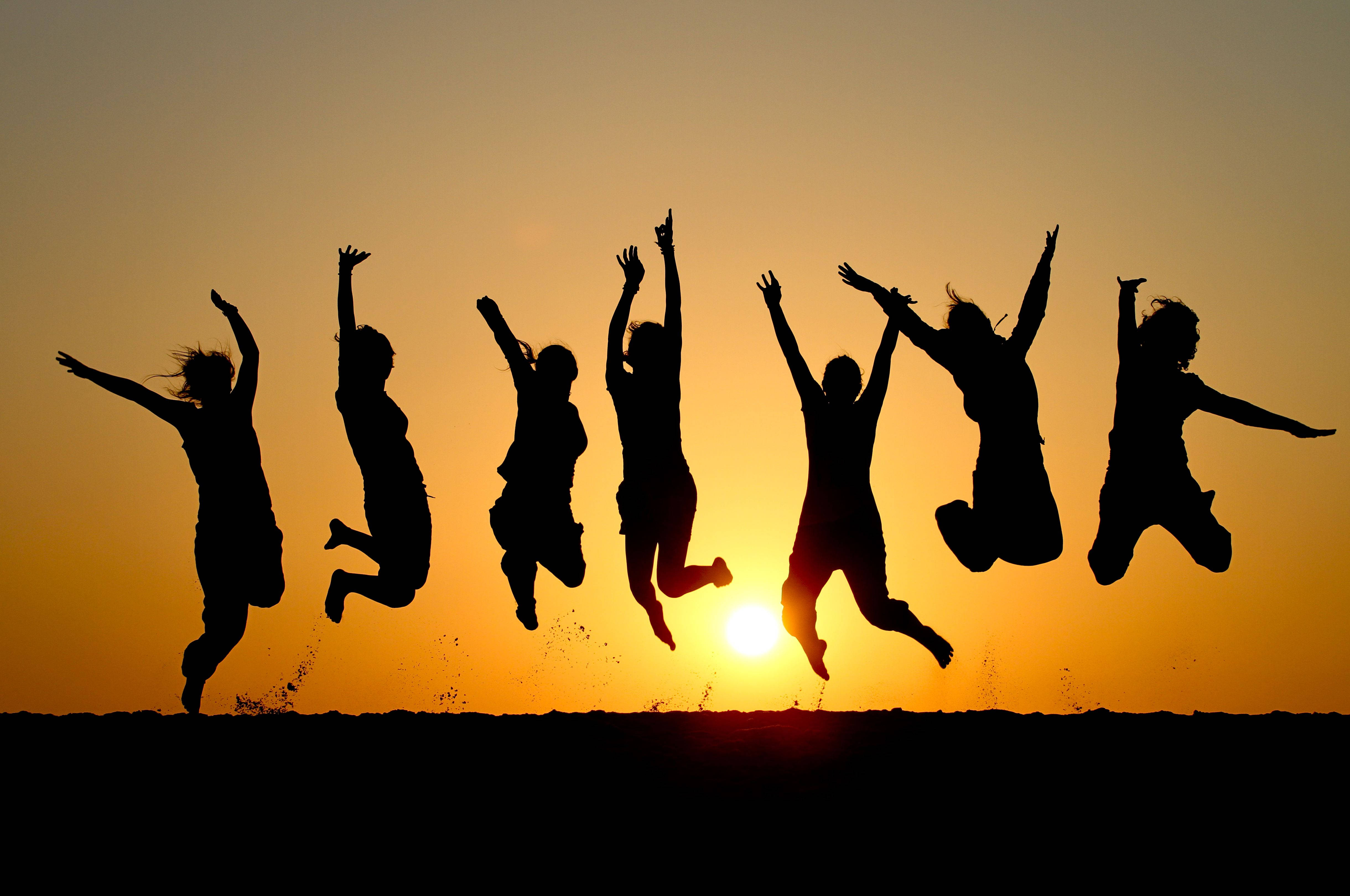 six joyful people, leaping in unison, glowing sunset sky, 4K Desktop Wallpaper