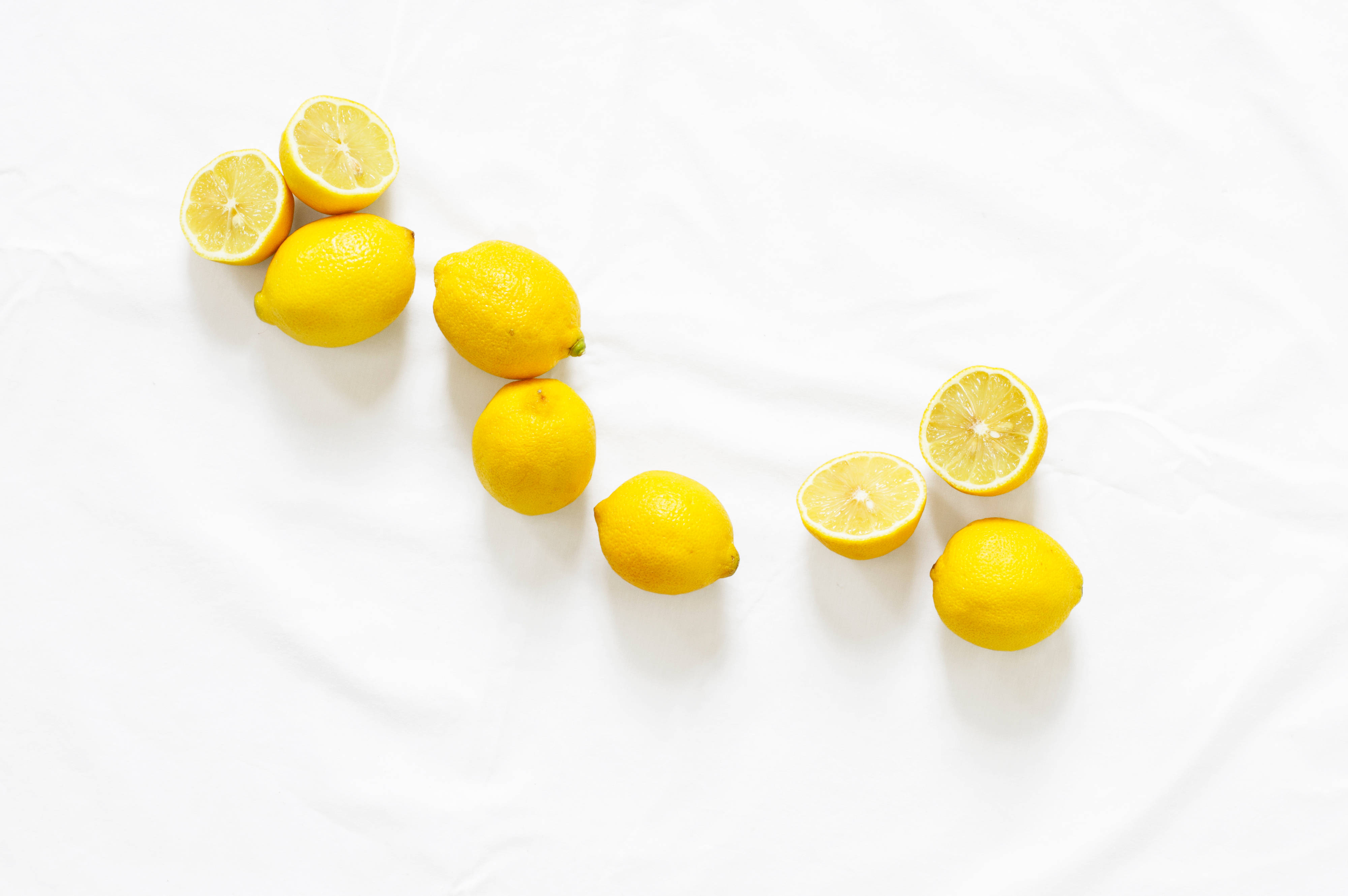 yellow lemons, white fabric background, whole and halved, 4K Desktop Wallpaper
