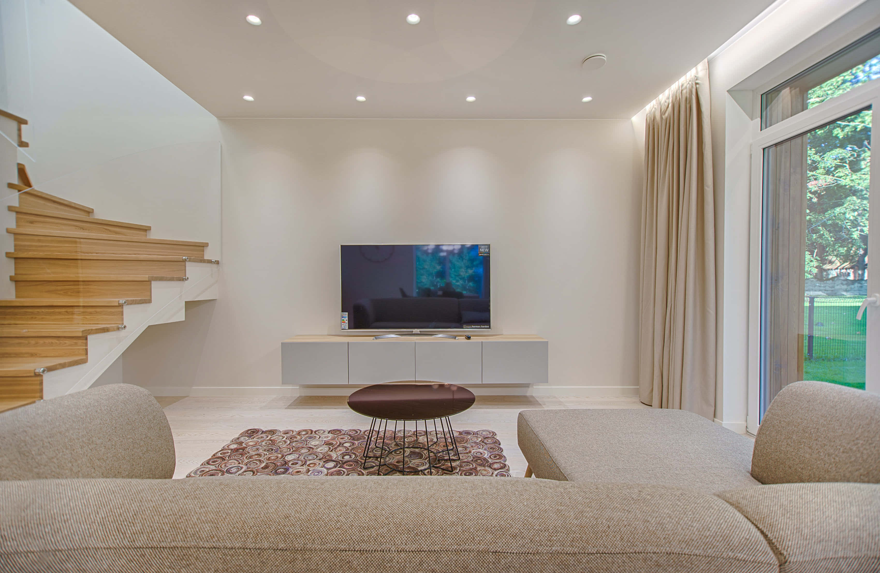 minimalist living room, beige sofa, wooden staircase, 2K Desktop Wallpaper