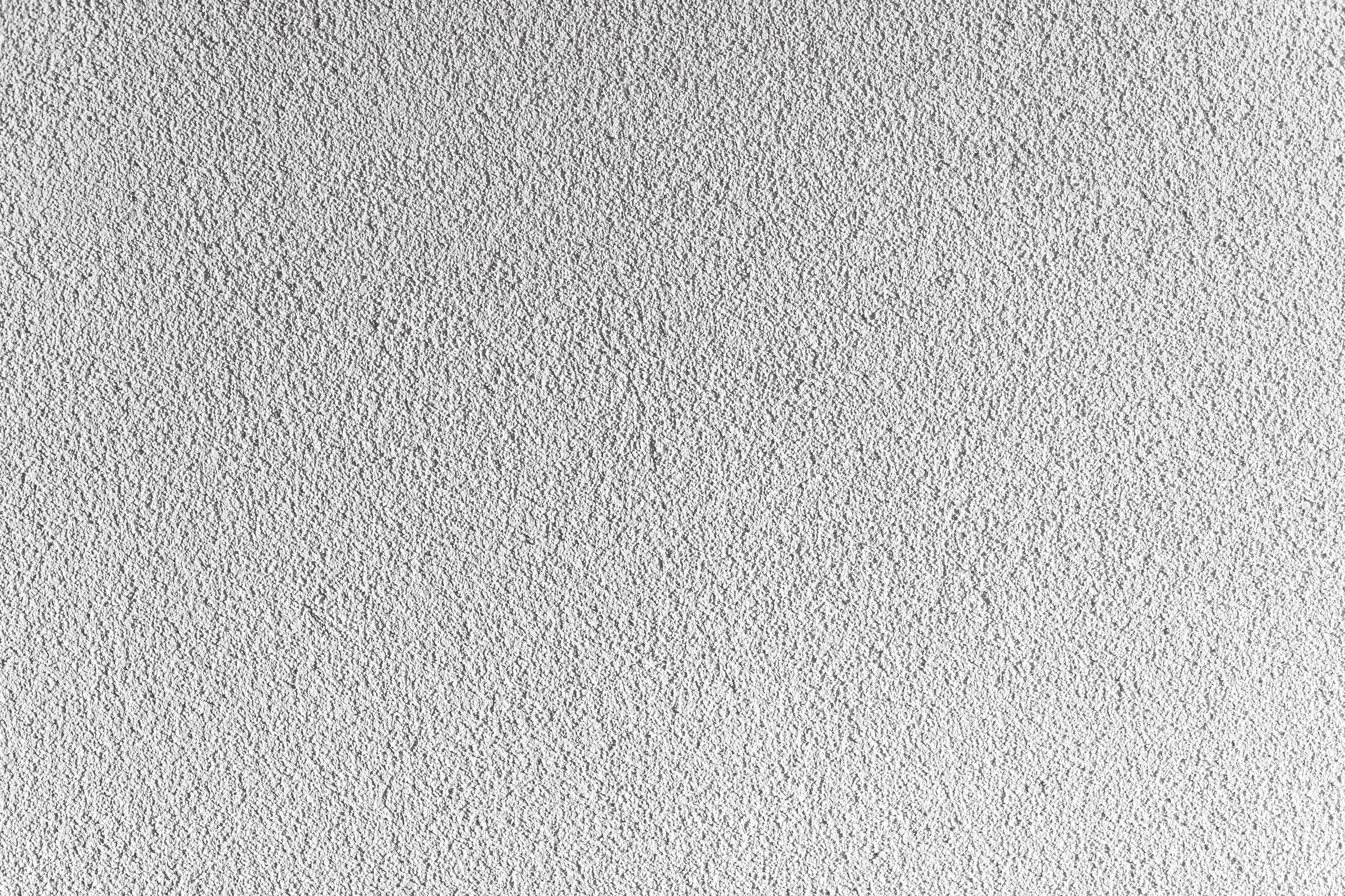 smooth white stucco wall, subtle texture, soft lighting, 5K Desktop Wallpaper