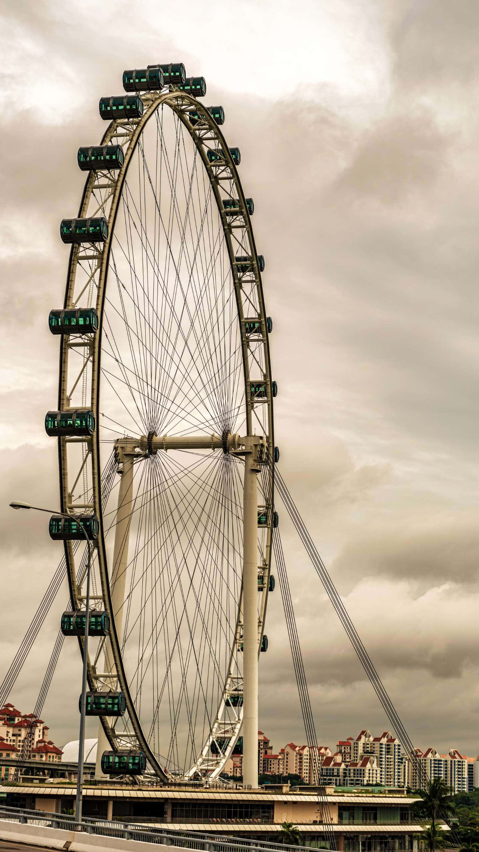 Singapore Flyer, cloudy sky, city buildings, 2K Phone Wallpaper