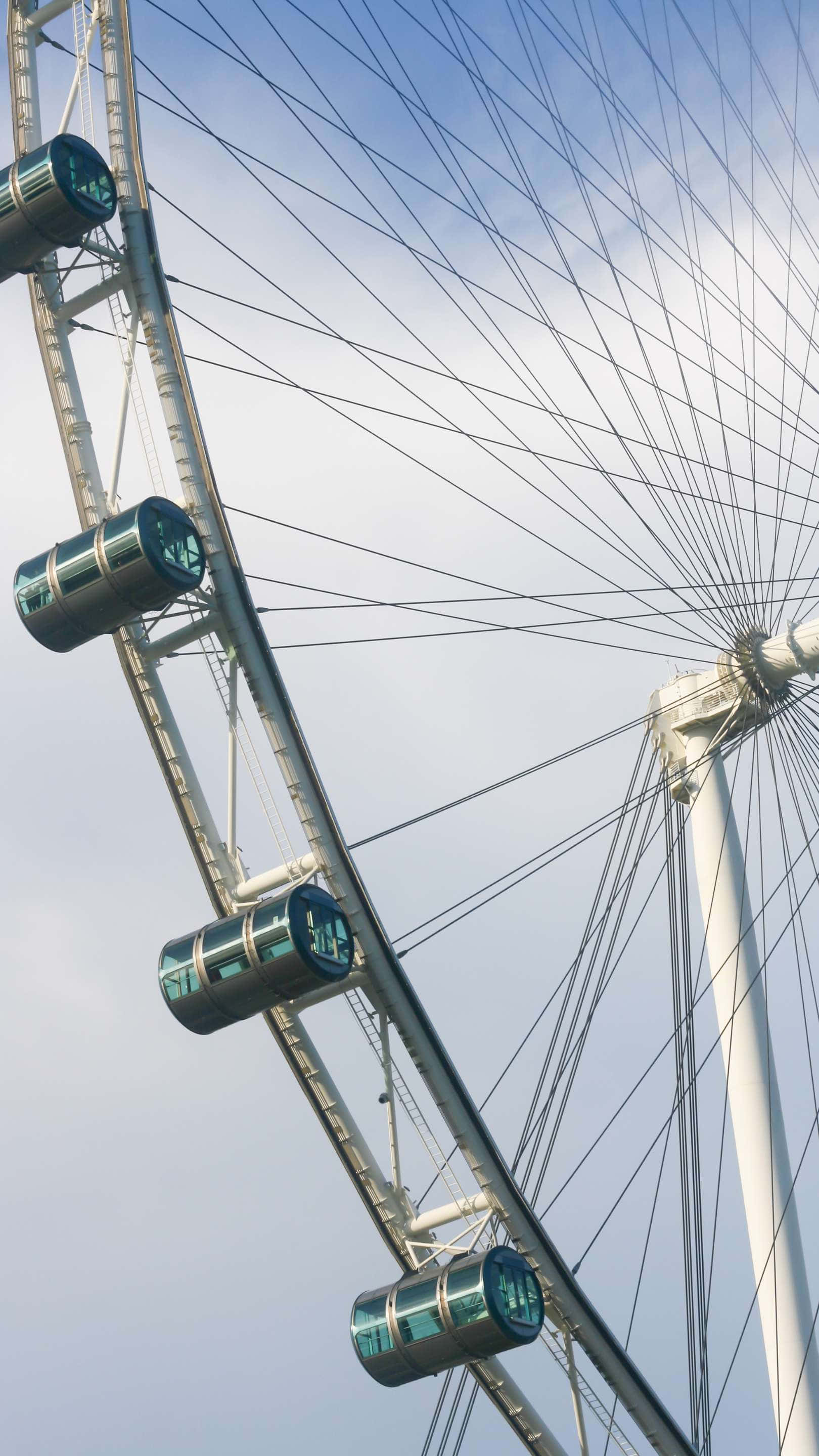 Singapore Flyer, sleek glass cabins, pale blue sky, 2K Phone Wallpaper