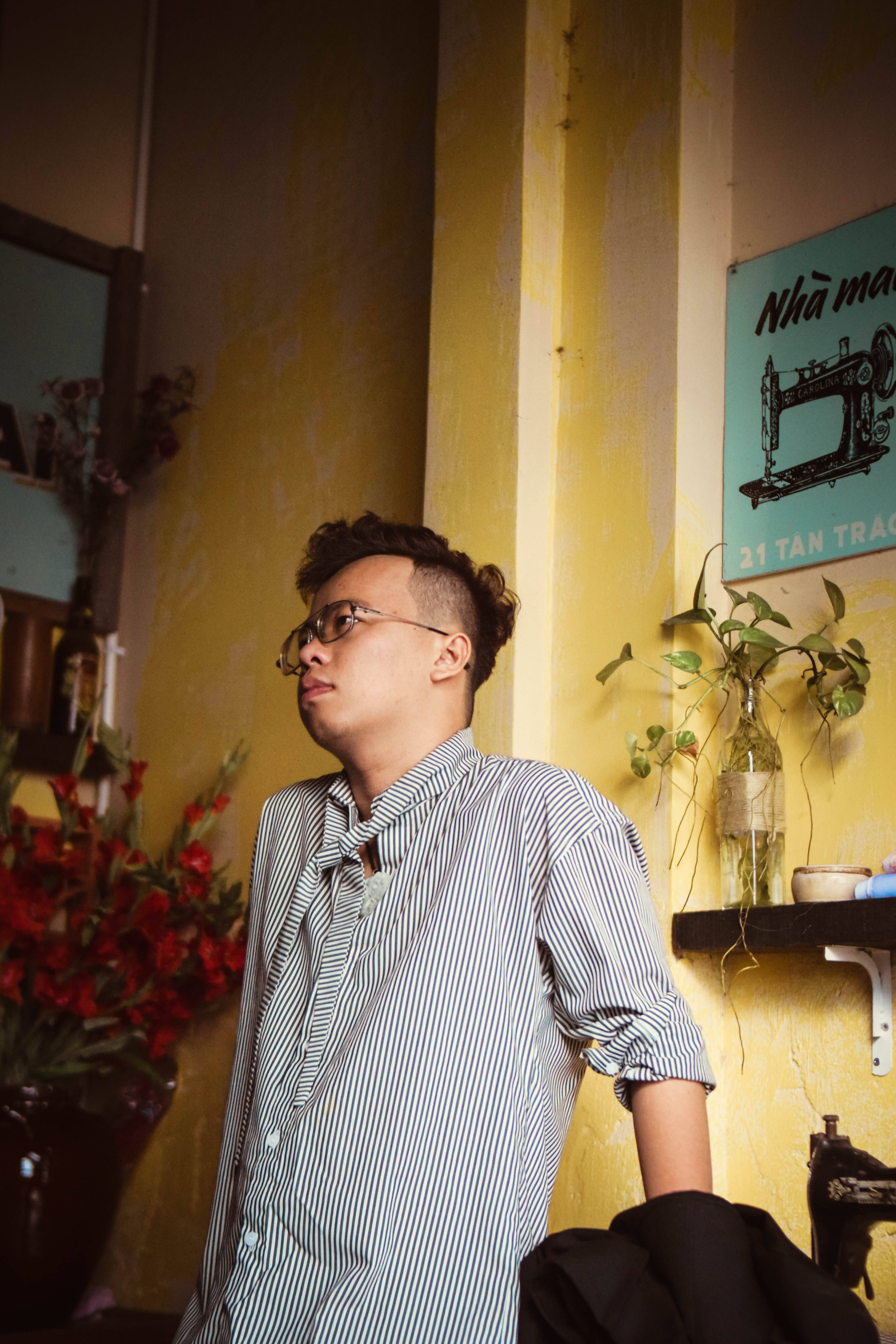 Single Boy, yellow wall, red flowers, 5K Phone Wallpaper