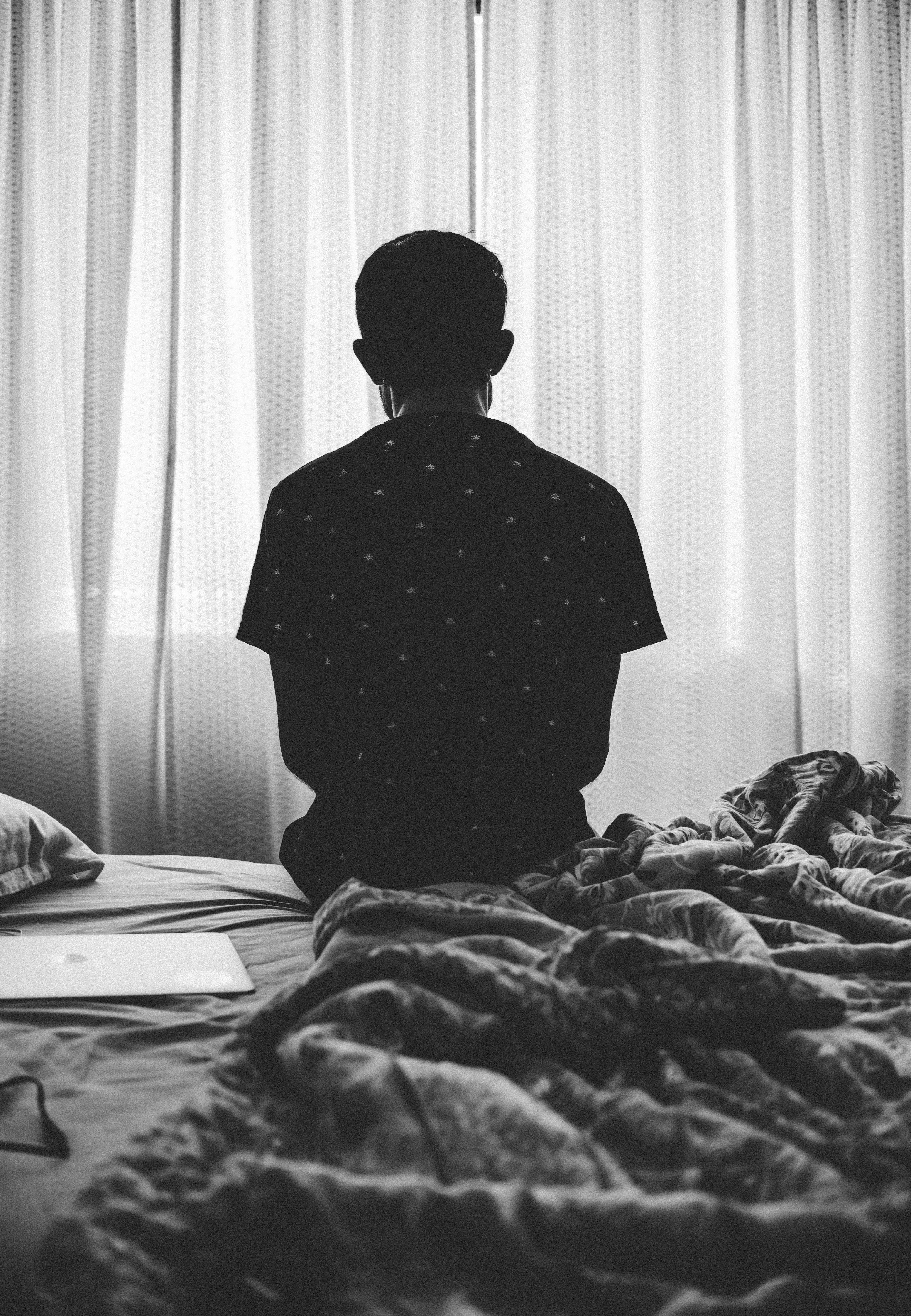 Single Boy, rumpled bed, sheer curtains, 5K Phone Wallpaper